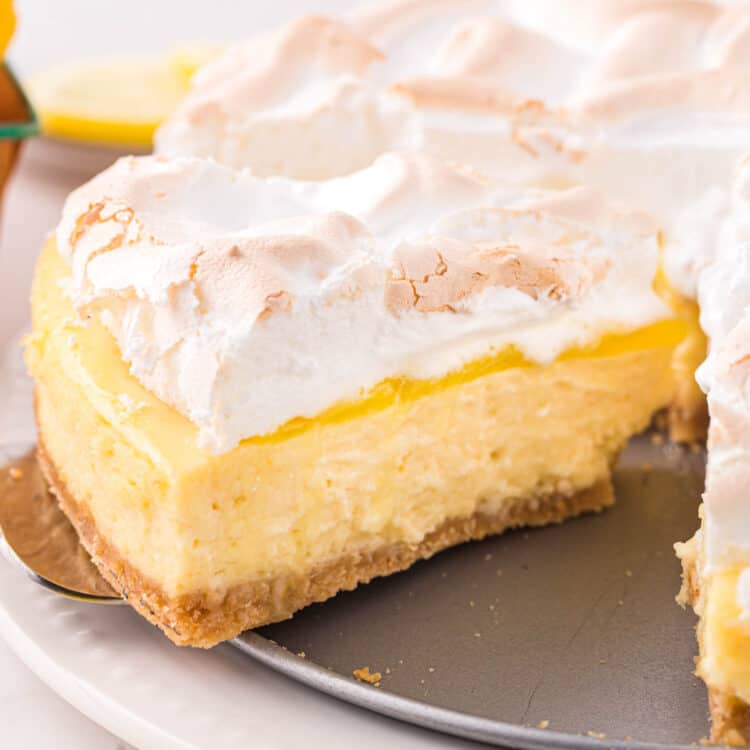 Lemon Meringue Cheesecake slice being taken from cheesecake