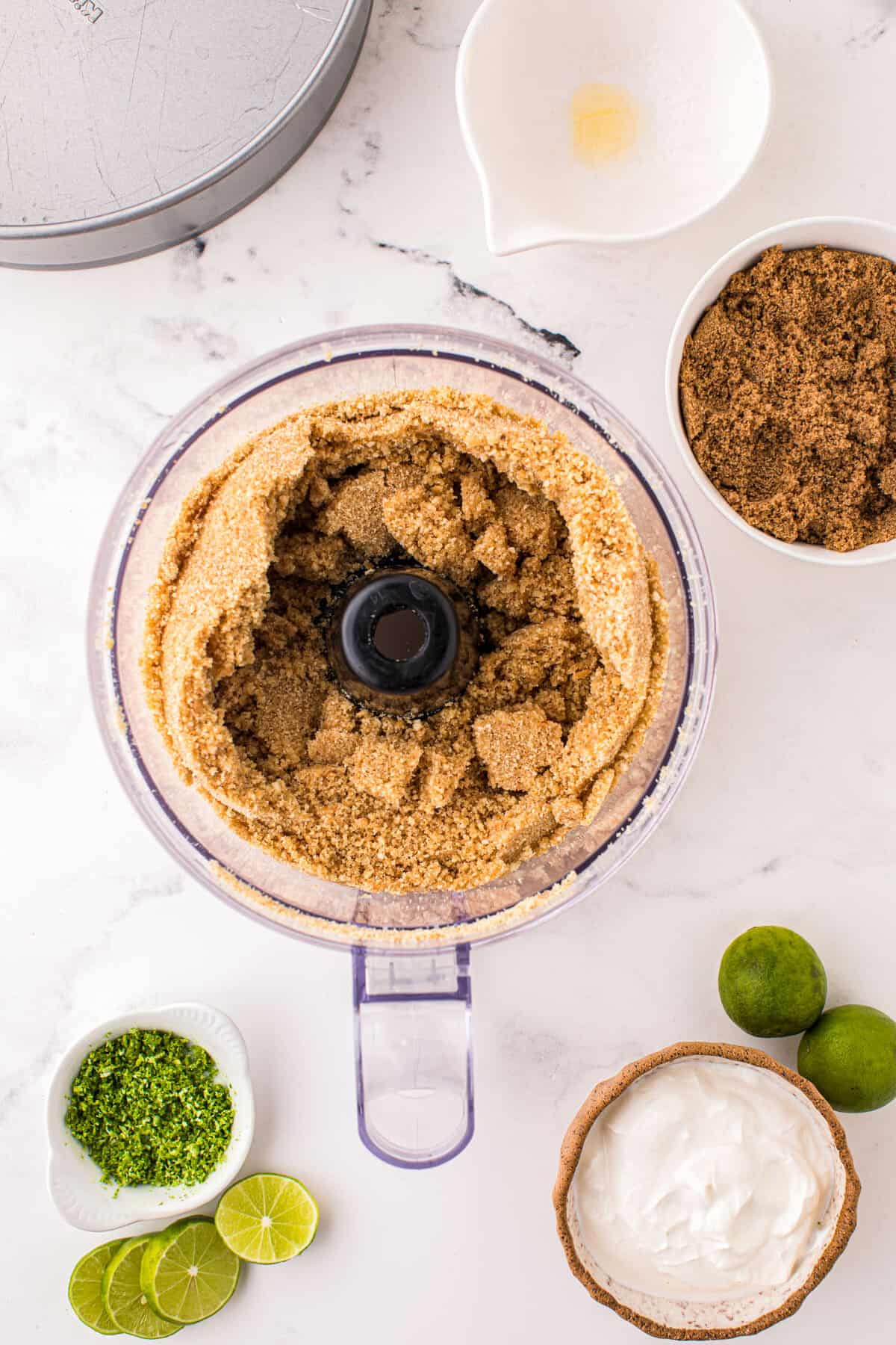 Using Food Processor to Blend Crust for Key Lime Pie Cheesecake