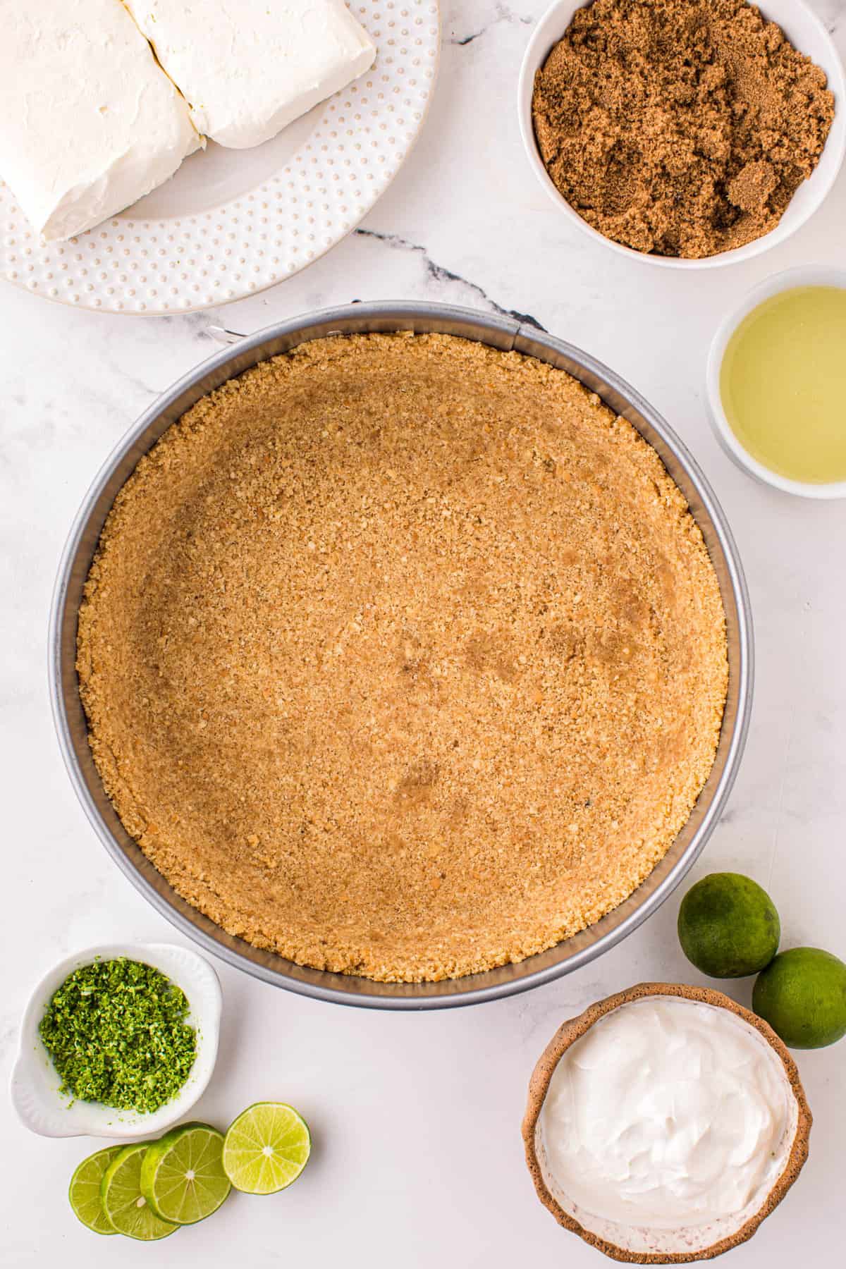 Pressing the Crust into Springform Pan for Key Lime Pie Cheesecake Recipe