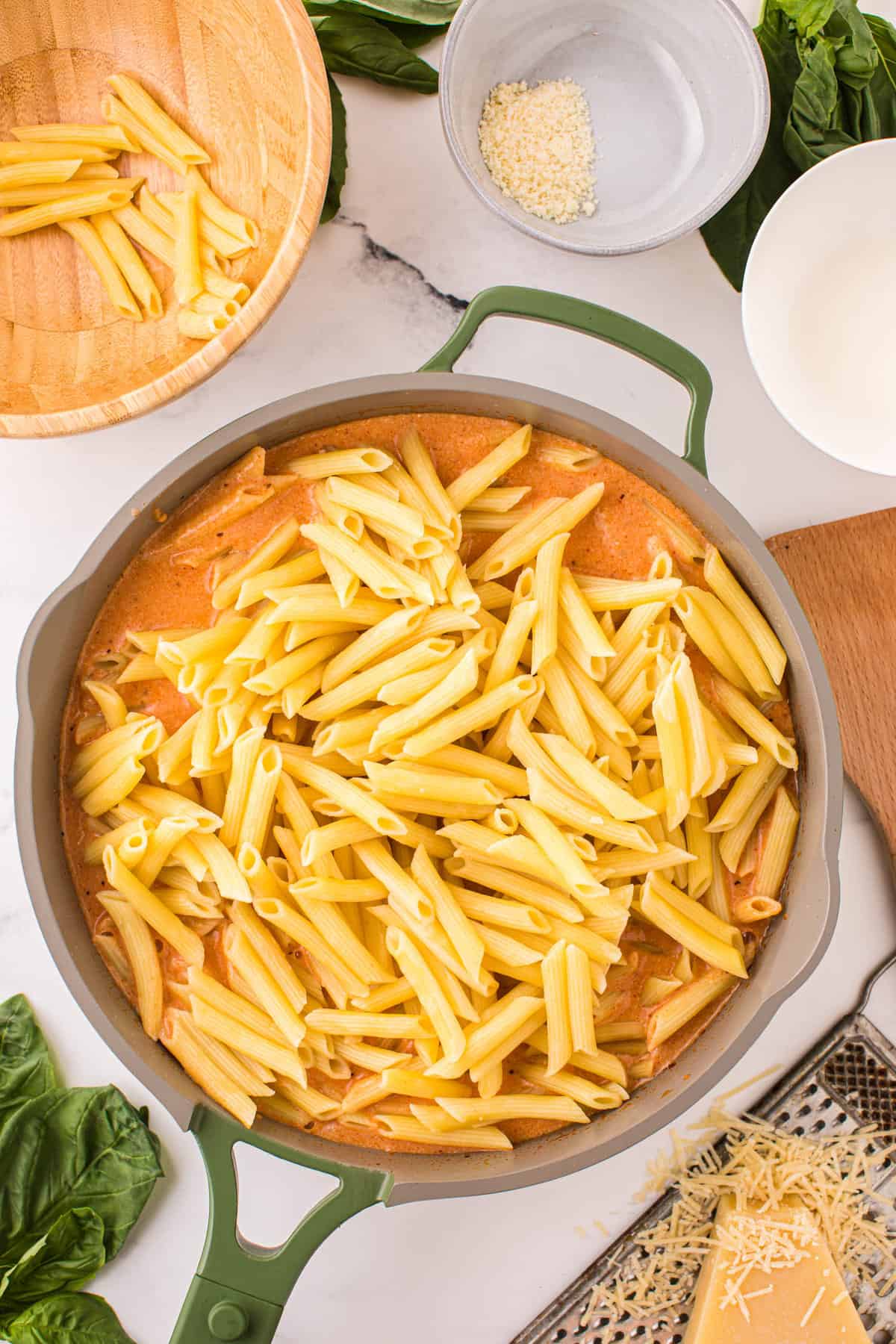 Adding Cooked Penne to Creamy Sauce for Penne alla Vodka