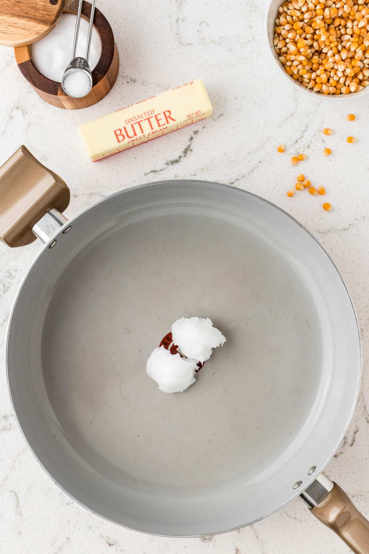 Melting Coconut Oil in Stovetop Pan for Homemade Popcorn