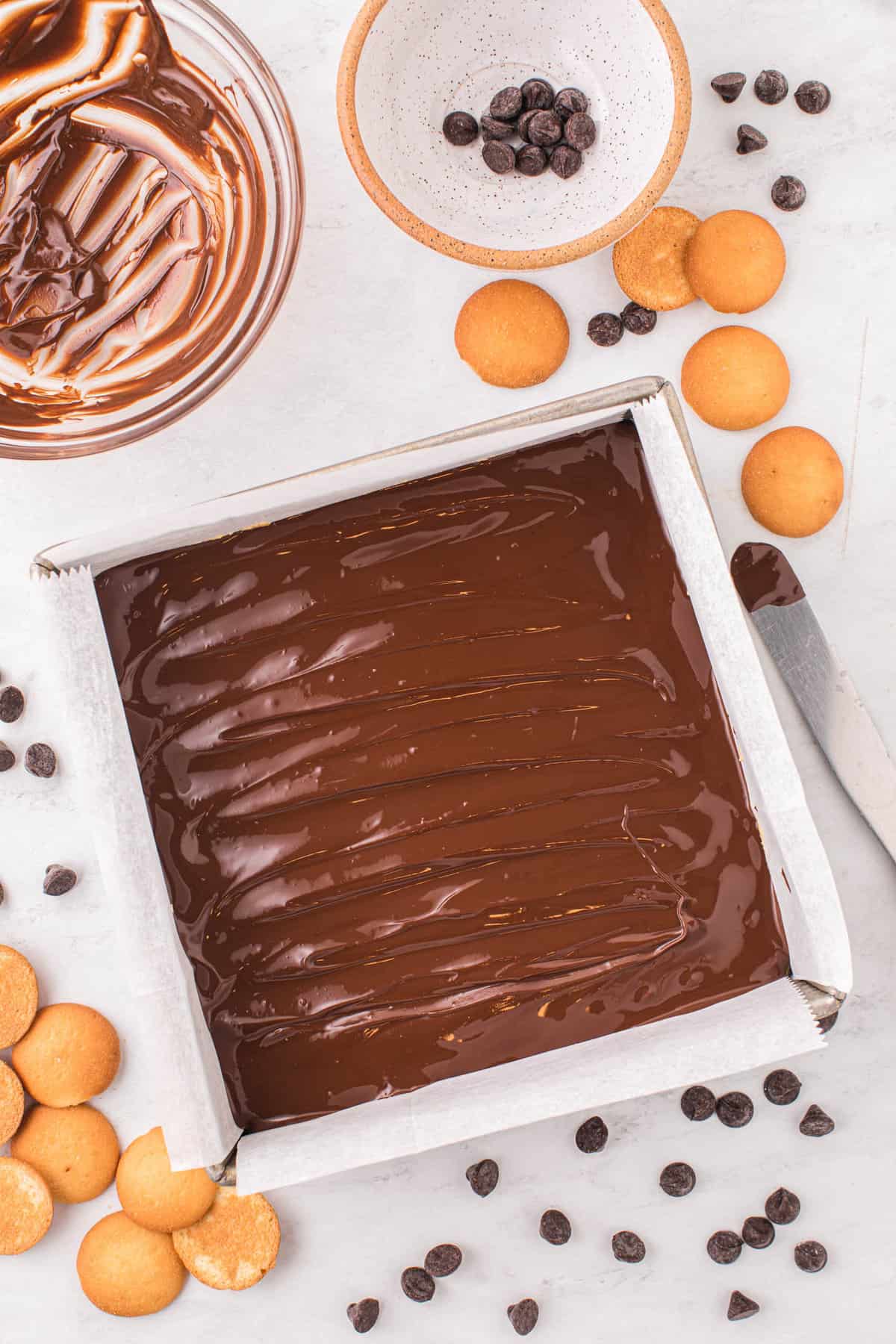 Spread out Chocolate Topping Over Peanut Butter Mixure in Pan for Chocolate Peanut Butter Bars