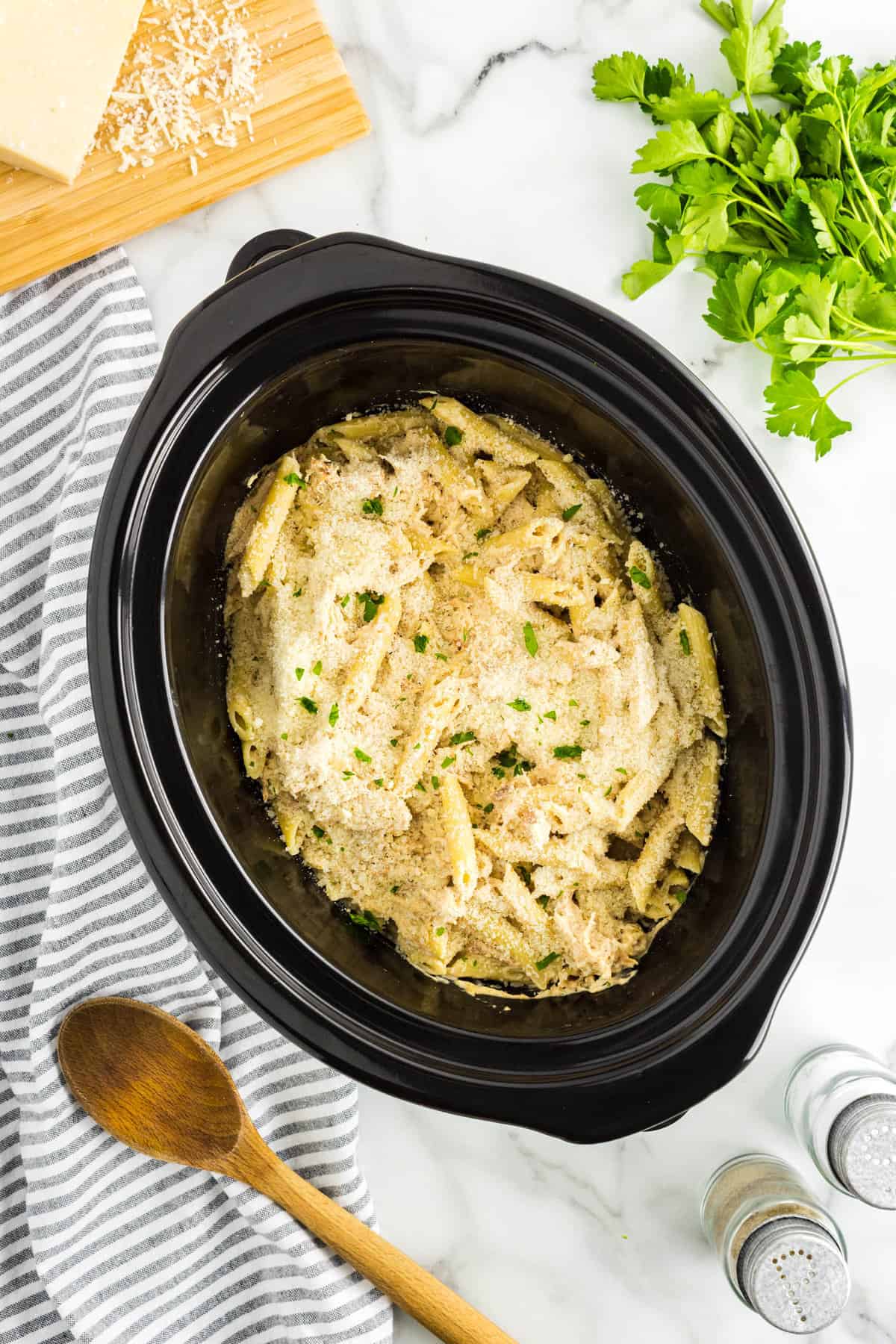 Adding Prepared Pasta to Crock Pot for Olive Garden Chicken Pasta Recipe