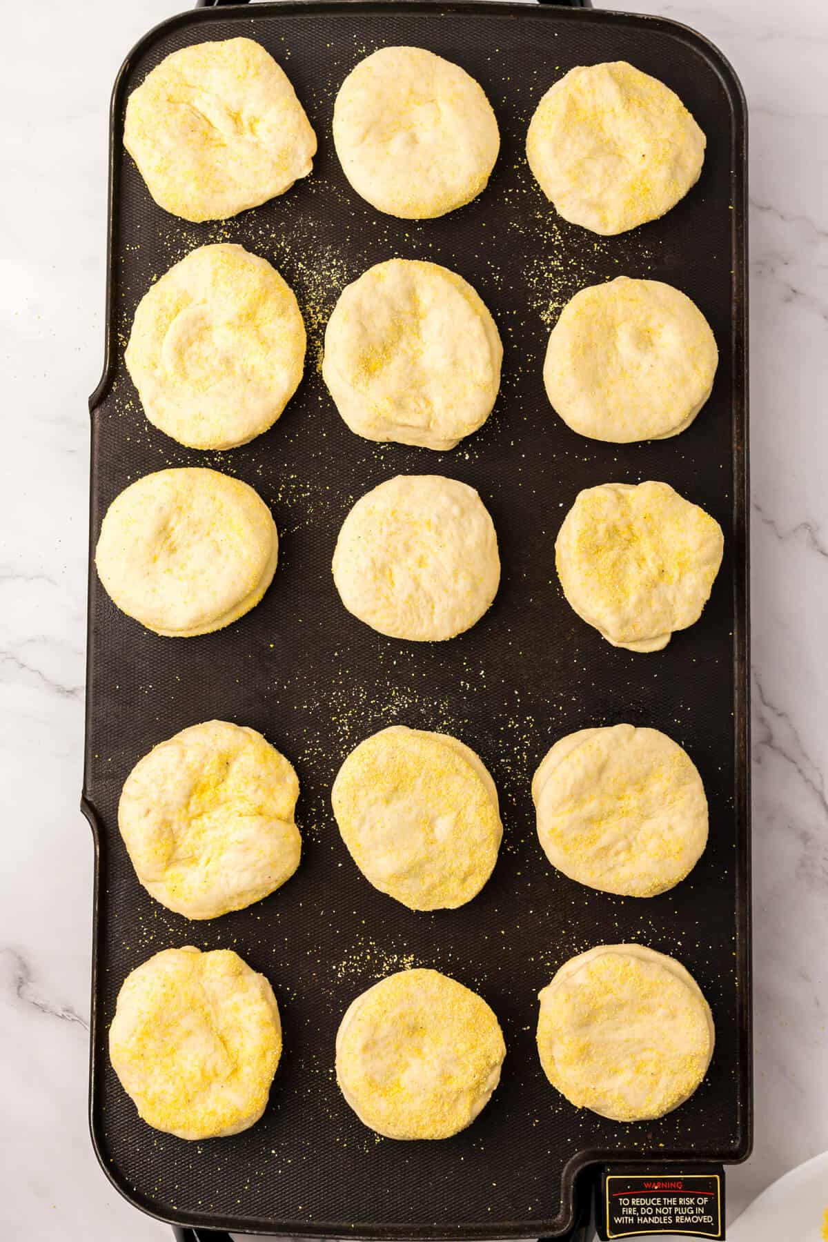 Placing Dough Discs on Non-Stick Skillet for Homemade English Muffins