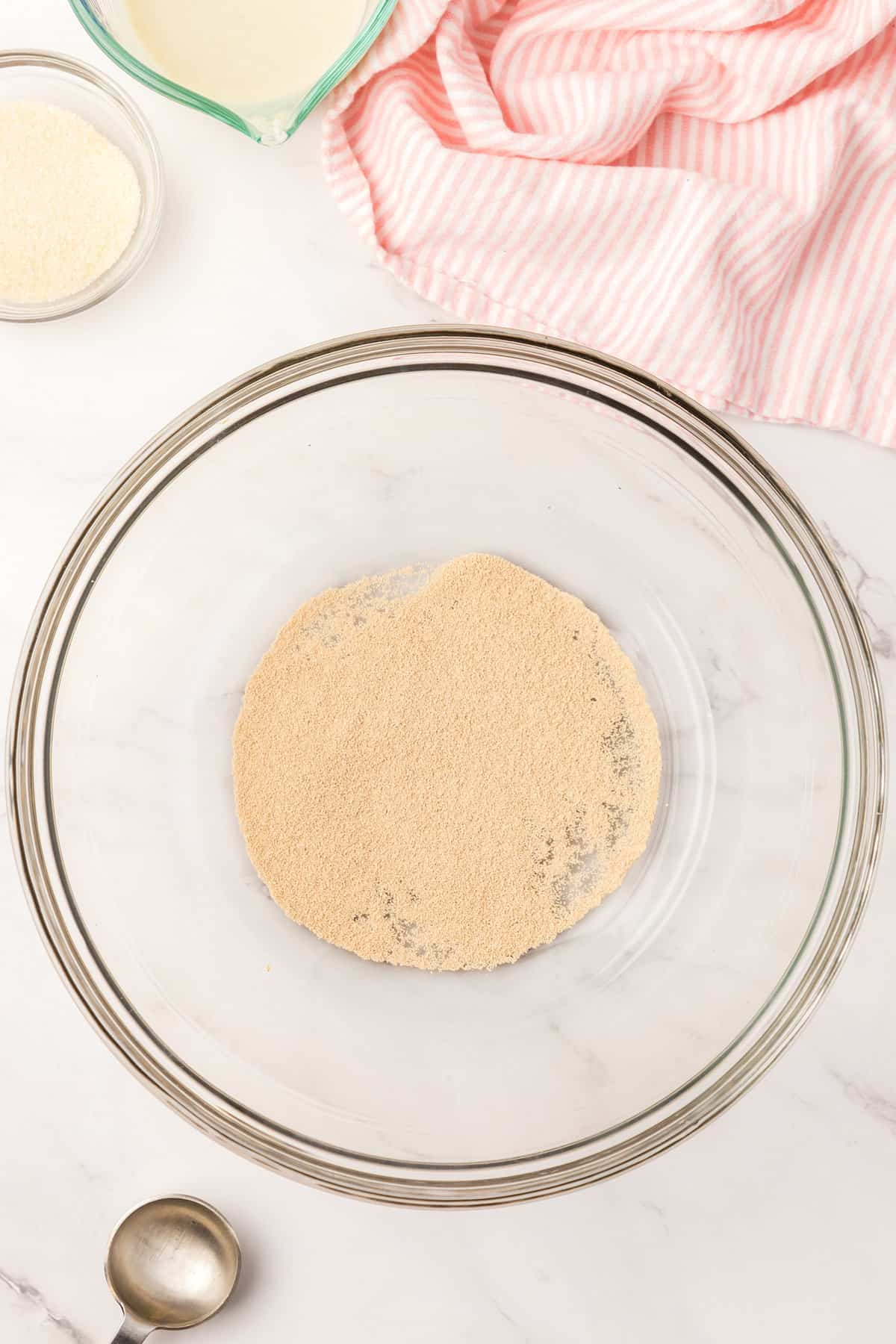 Dry Yeast in Clear Mixing Bowl for Homemade Engilsh Muffins