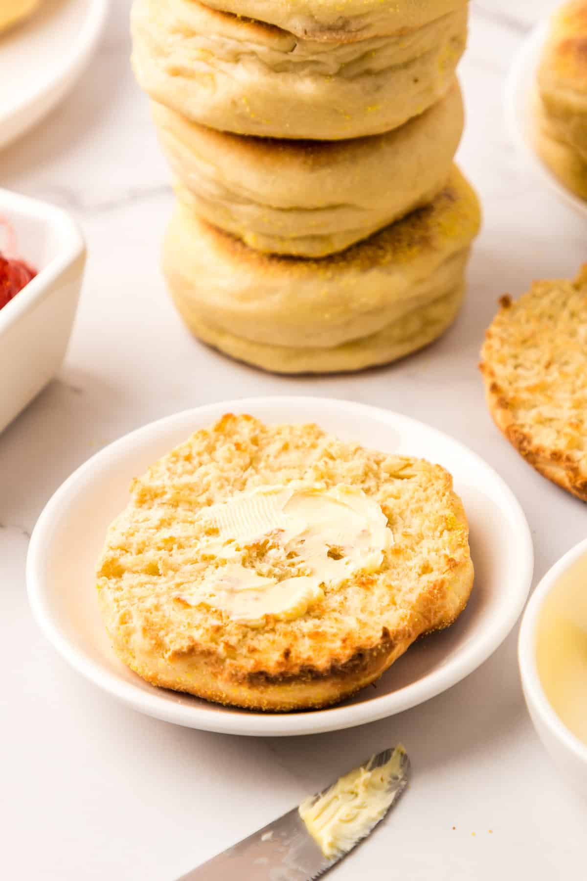 Smearing Butter on Fresh Homemade English Muffins