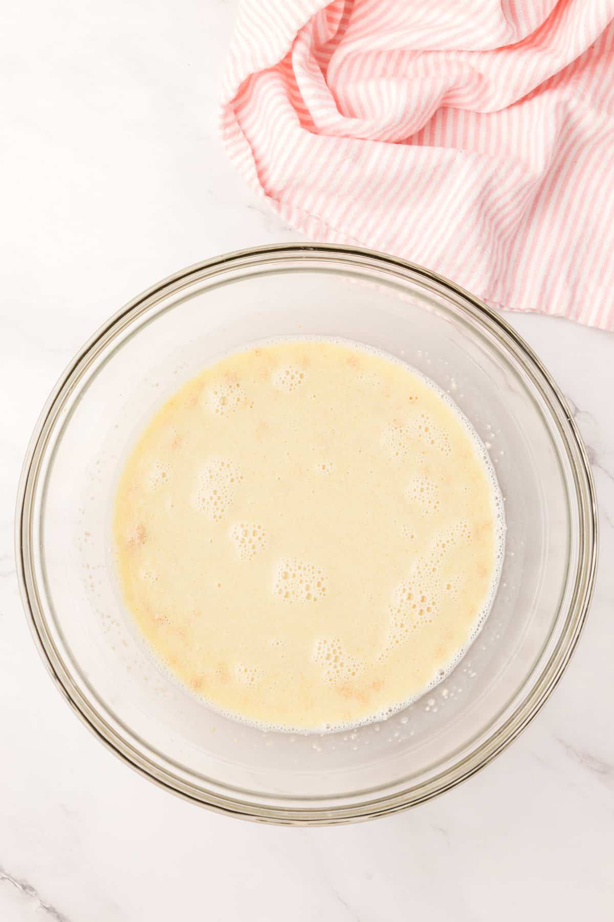 Pouring Mixture over Yeast for Homemade English Muffins