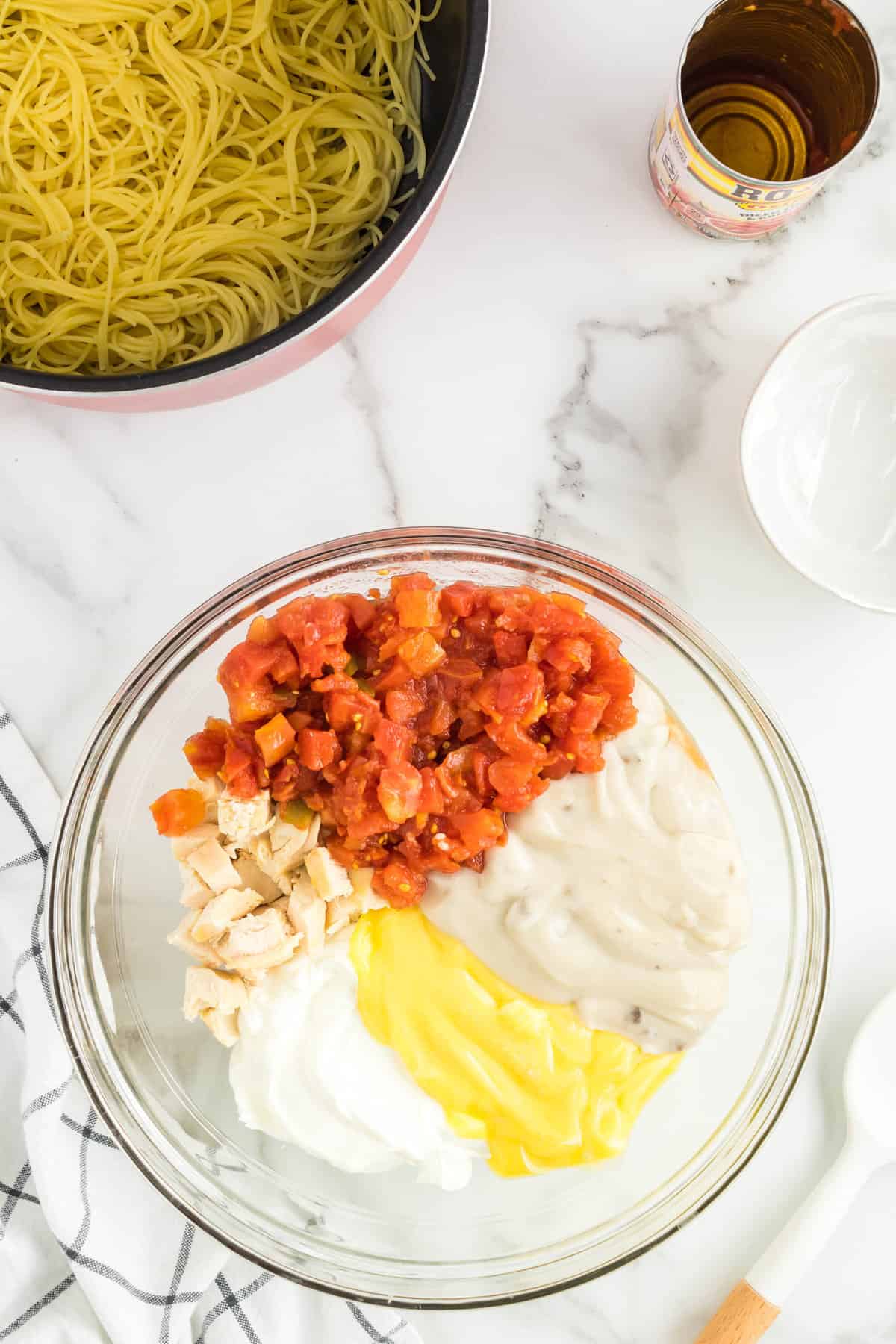 Combining All Ingredients Except for Cheese and Pasta in Mixing Bowl for Mexican Chicken Spaghetti