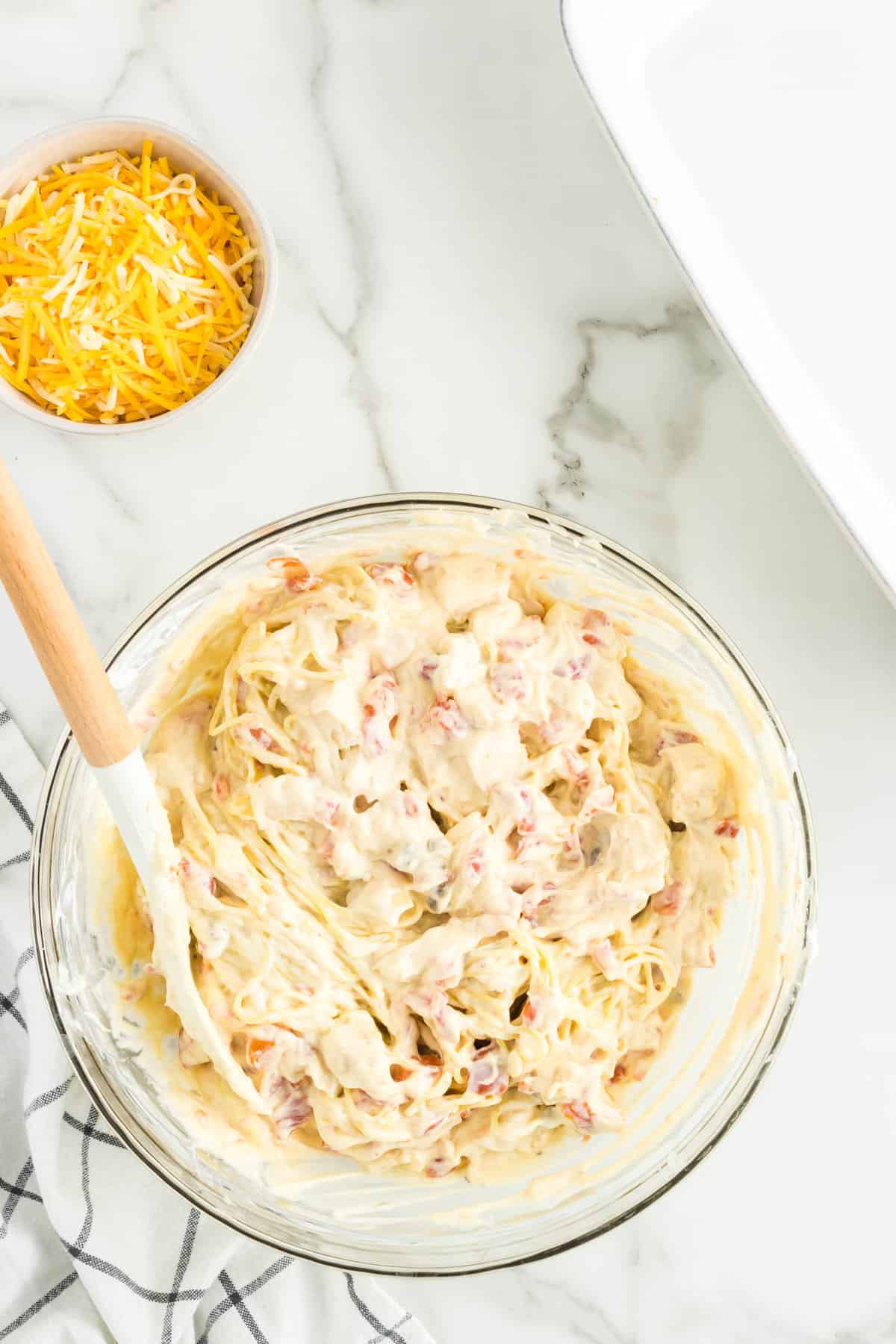 Stirring Pasta into Mixture for Mexican Chicken Spaghetti Recipe