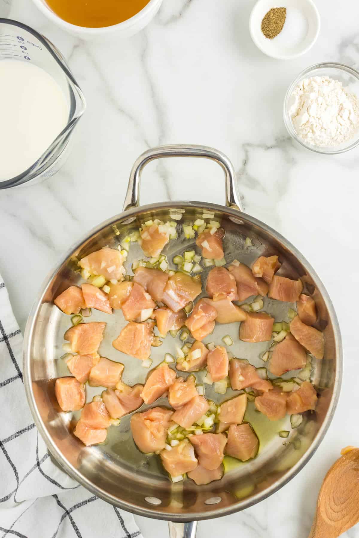 Cooking Chicken and Garlic in Olive Oil for One Pot Chicken Spaghetti Recipe