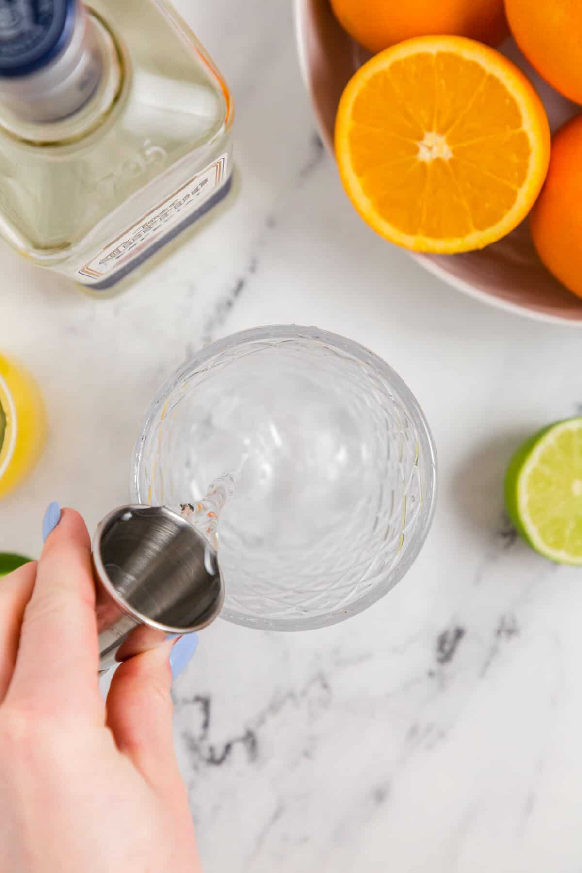 Measuring out Tequila with Shot Glass for Skinny Margarita