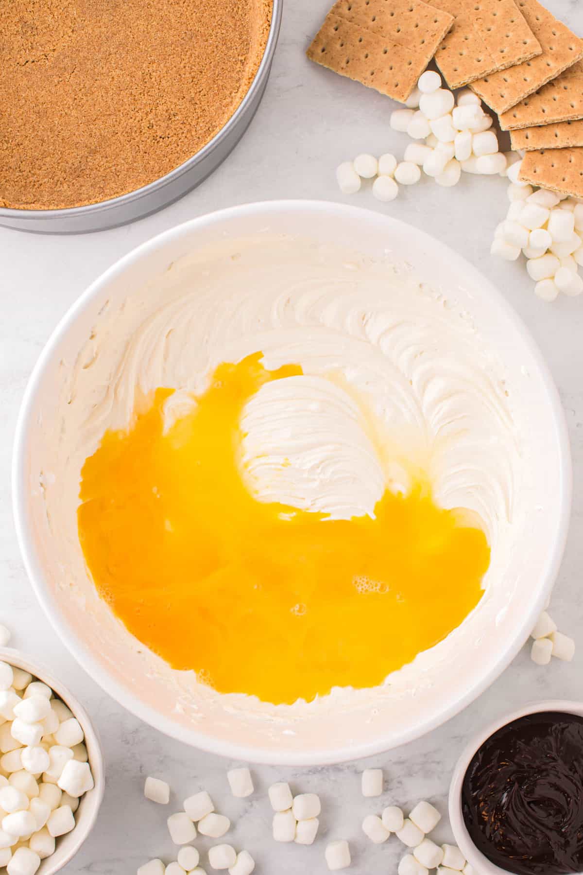 Adding Eggs to Cheesecake Filling Mixture for Smores Cheesecake Recipe