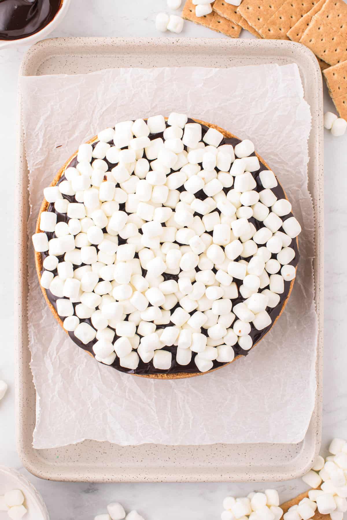 Topping Cheesecake with Mini Marshmallows for S'mores Cheesecake Recipe