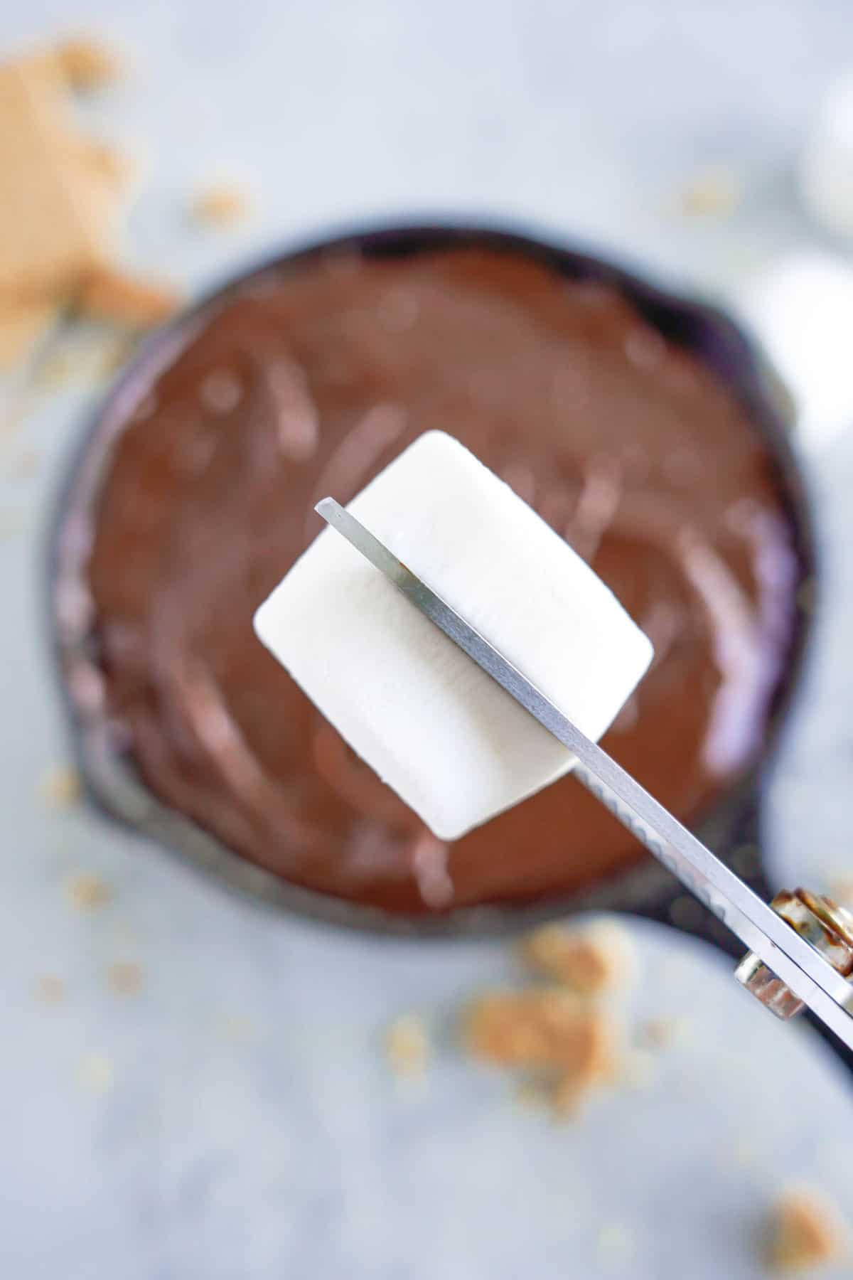 Halving Marshmallows to Top Smores Dip Recipe Before Baking