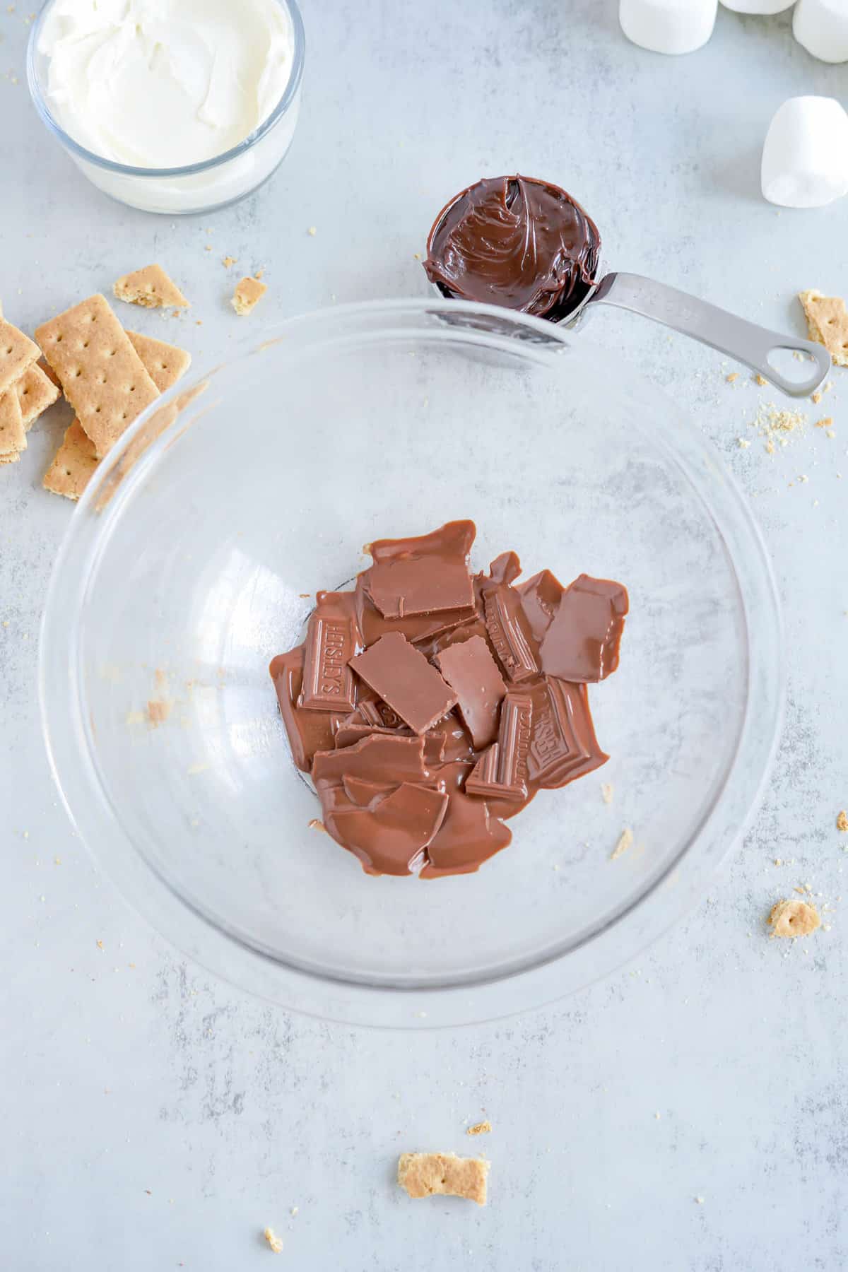 Slightly Melted Chocolate Pieces in Glass Bowl for S mores Dip