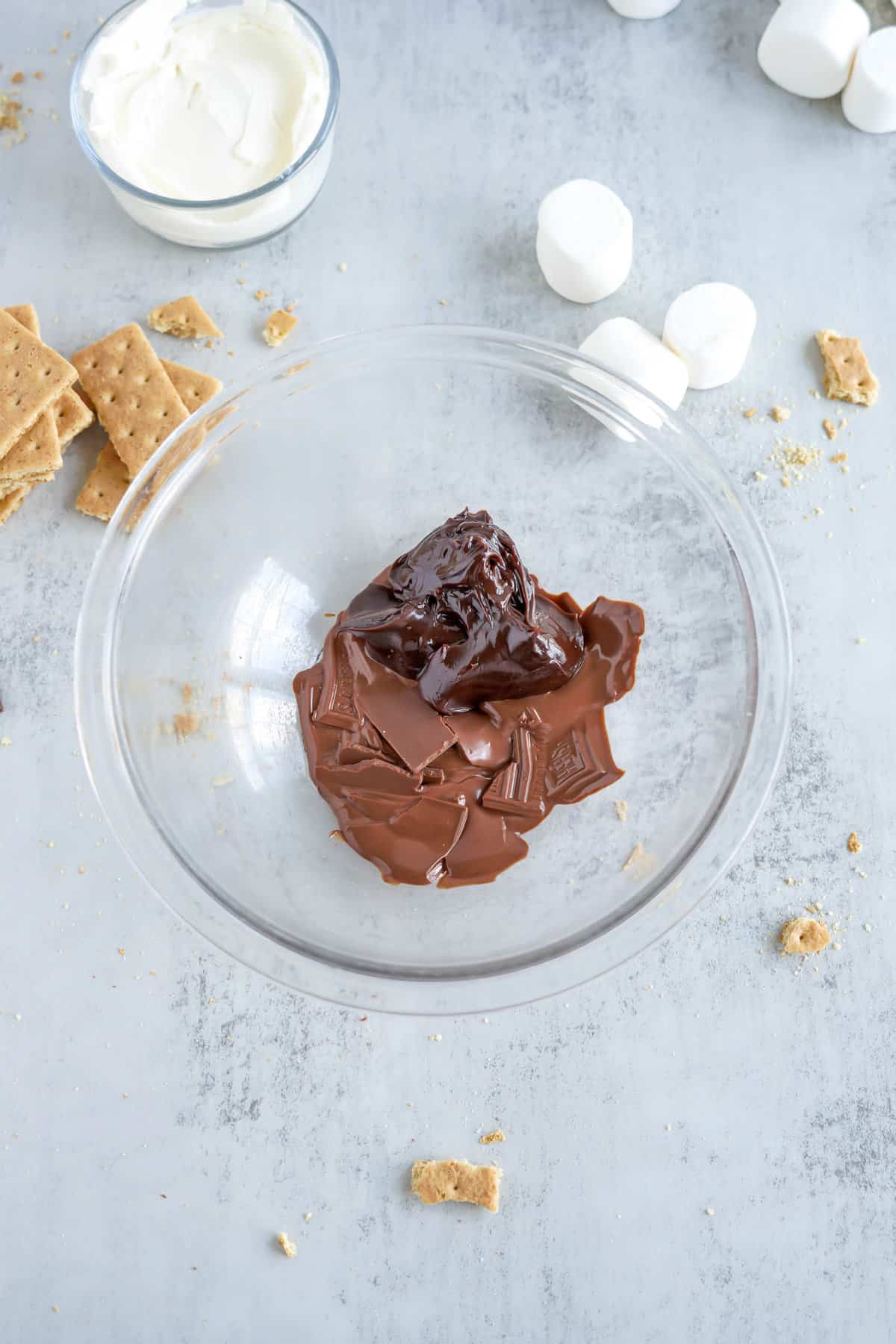 Adding in Fudge to Melted Chocolate for Easy S mores Dip