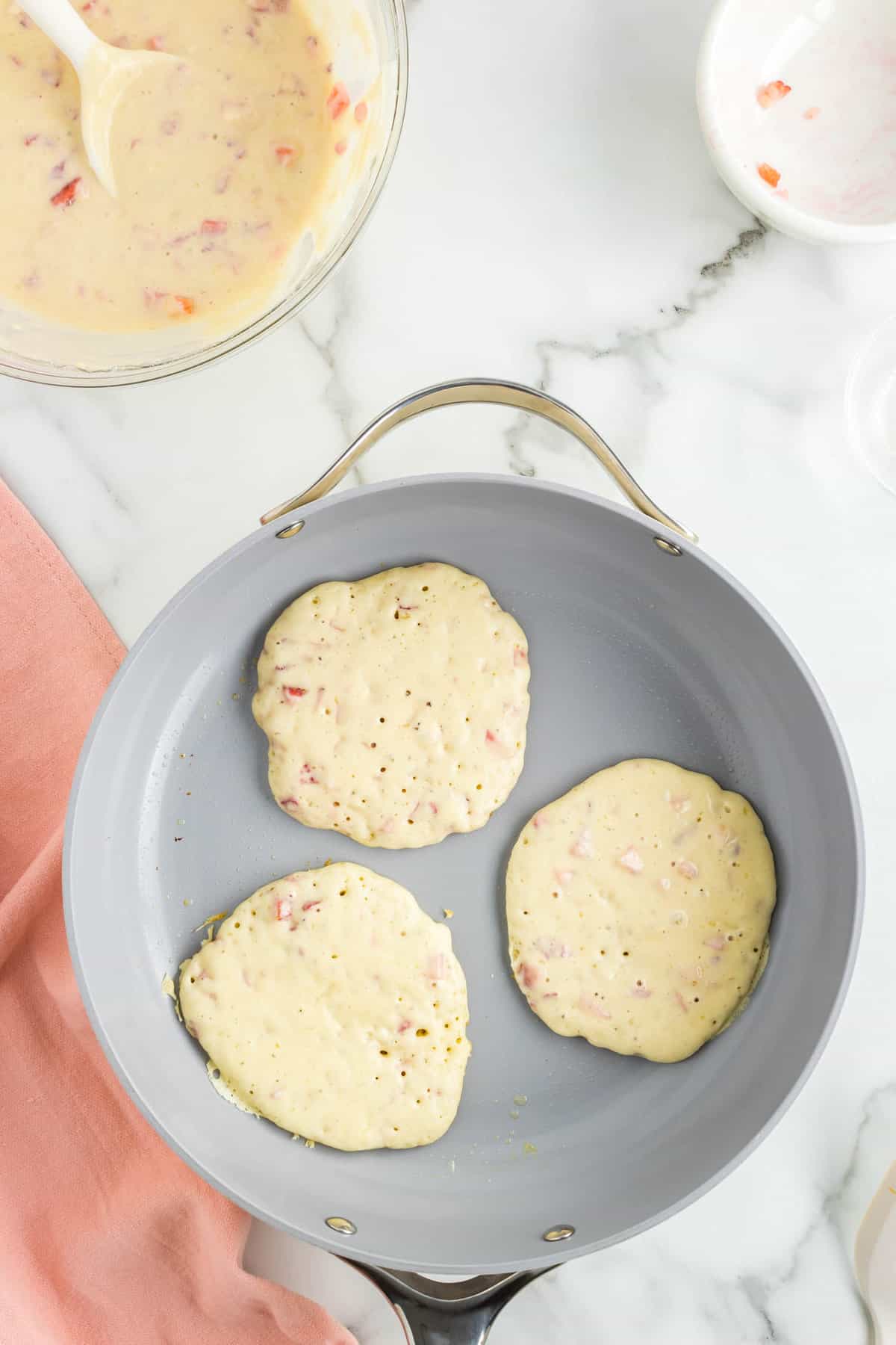 Pancakes on Griddle for Strawberry Pancake Recipe