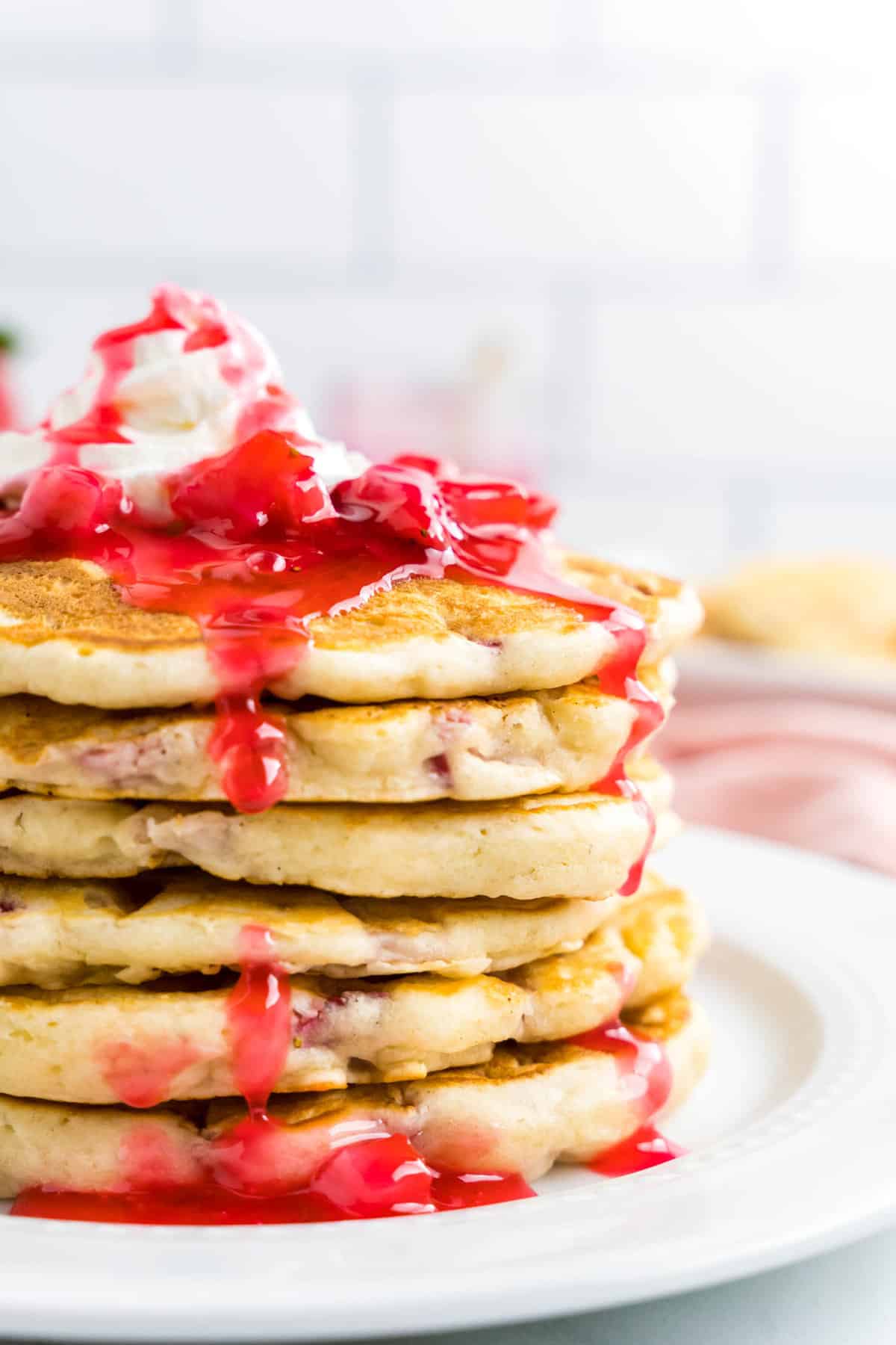 Strawberry Pancakes Topped with Whipped Cream and Strawberry Syrup Ready to Enjoy