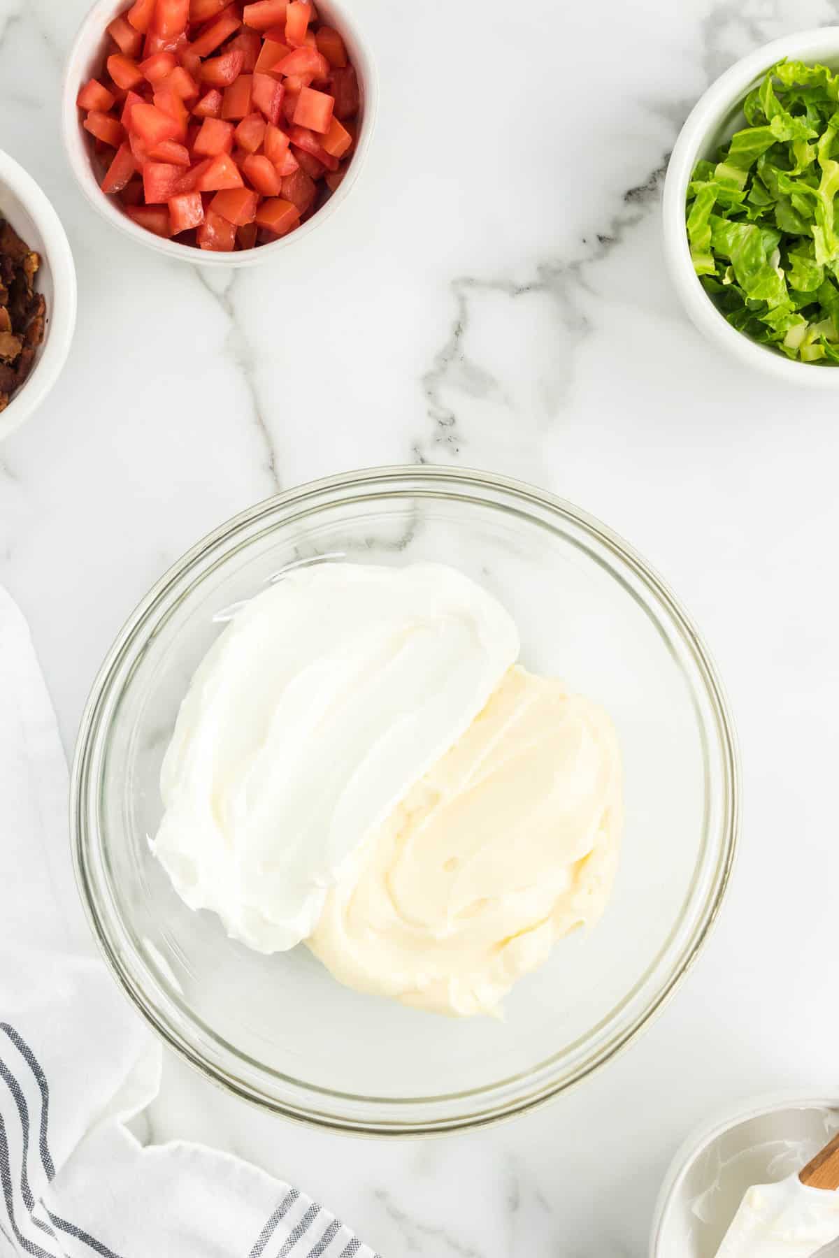 Sour cream and mayonnaise in mixing bowl for BLT Dip recipe