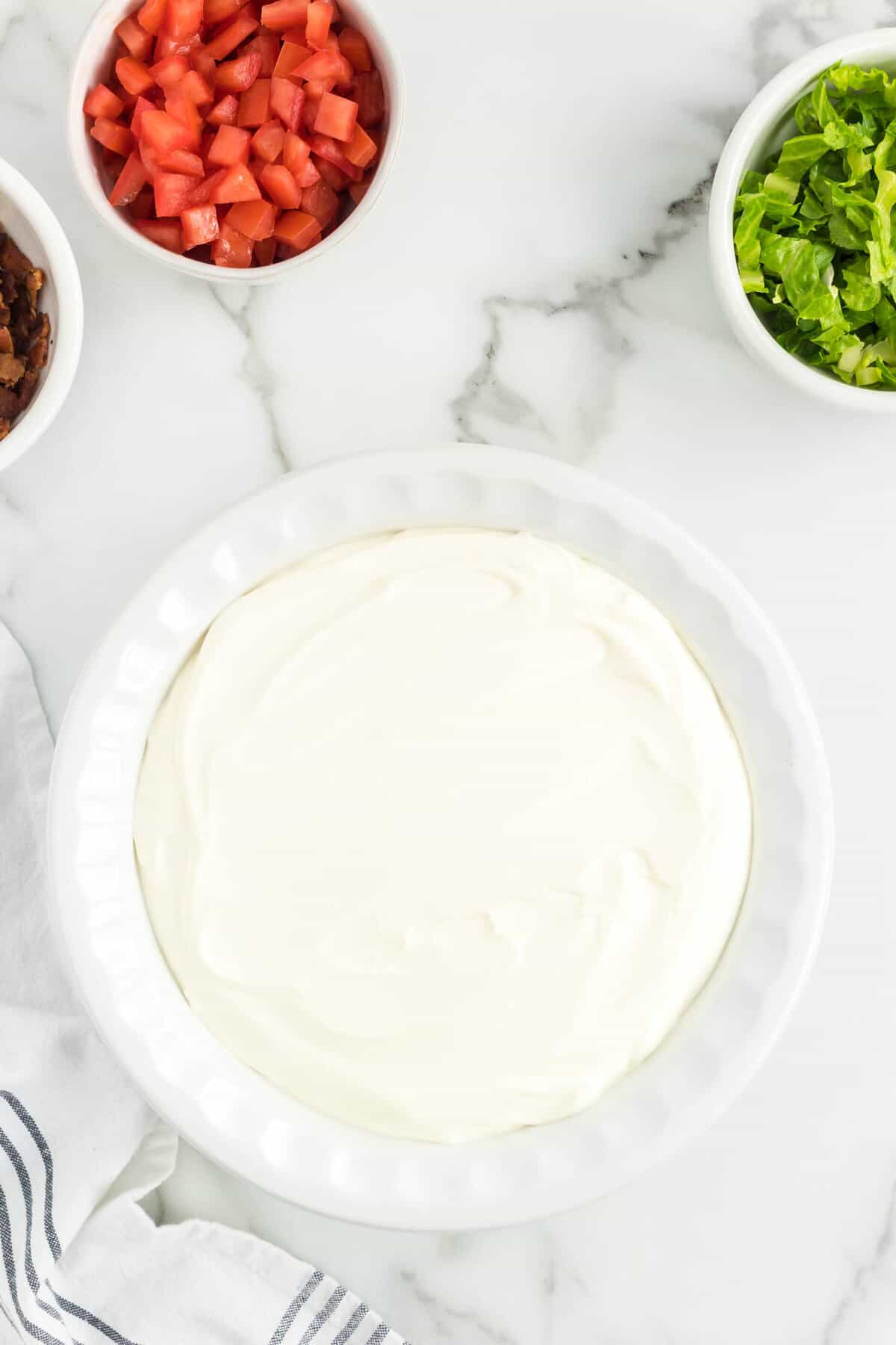 Combined mayonnaise and sour cream in shallow dish for BLT Dip