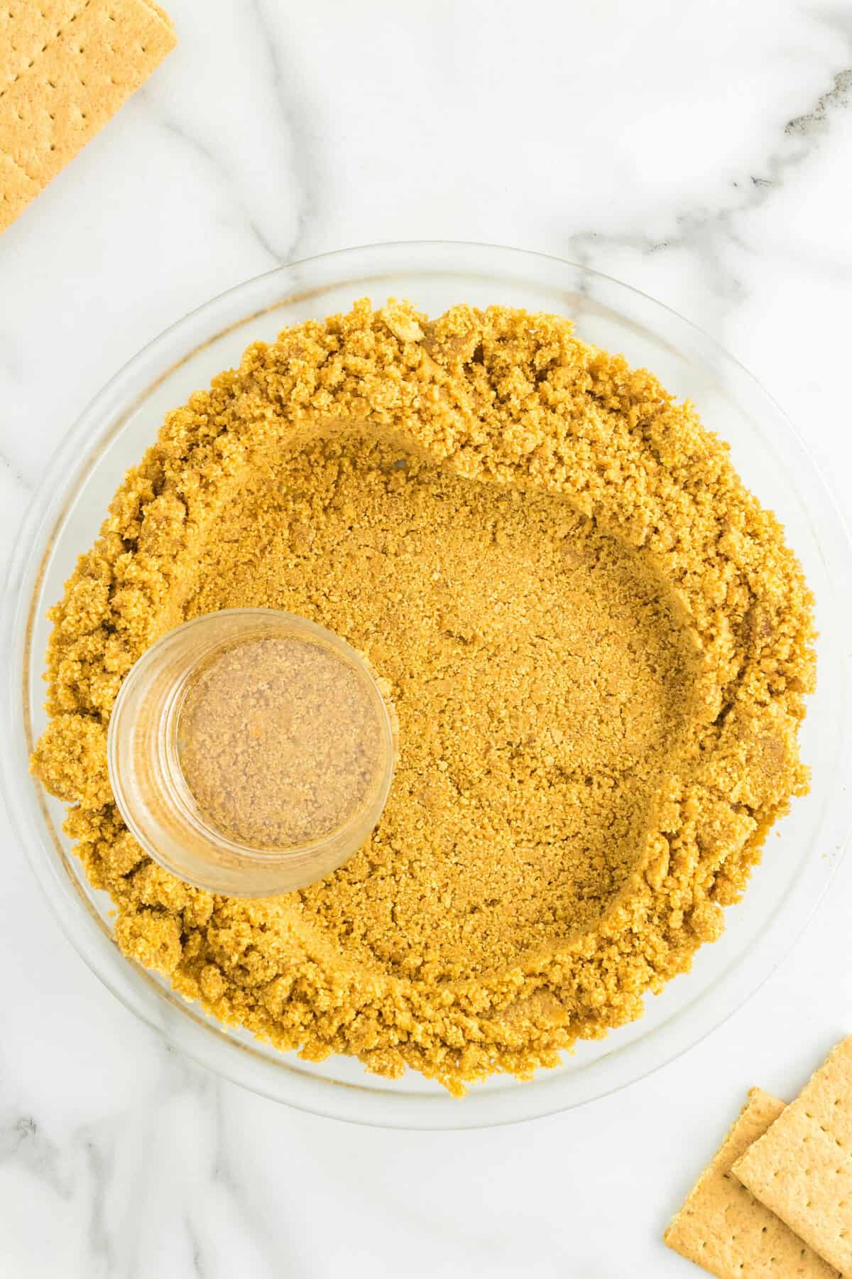 Pressing Graham Cracker Crust into Pie Plate Using Glass