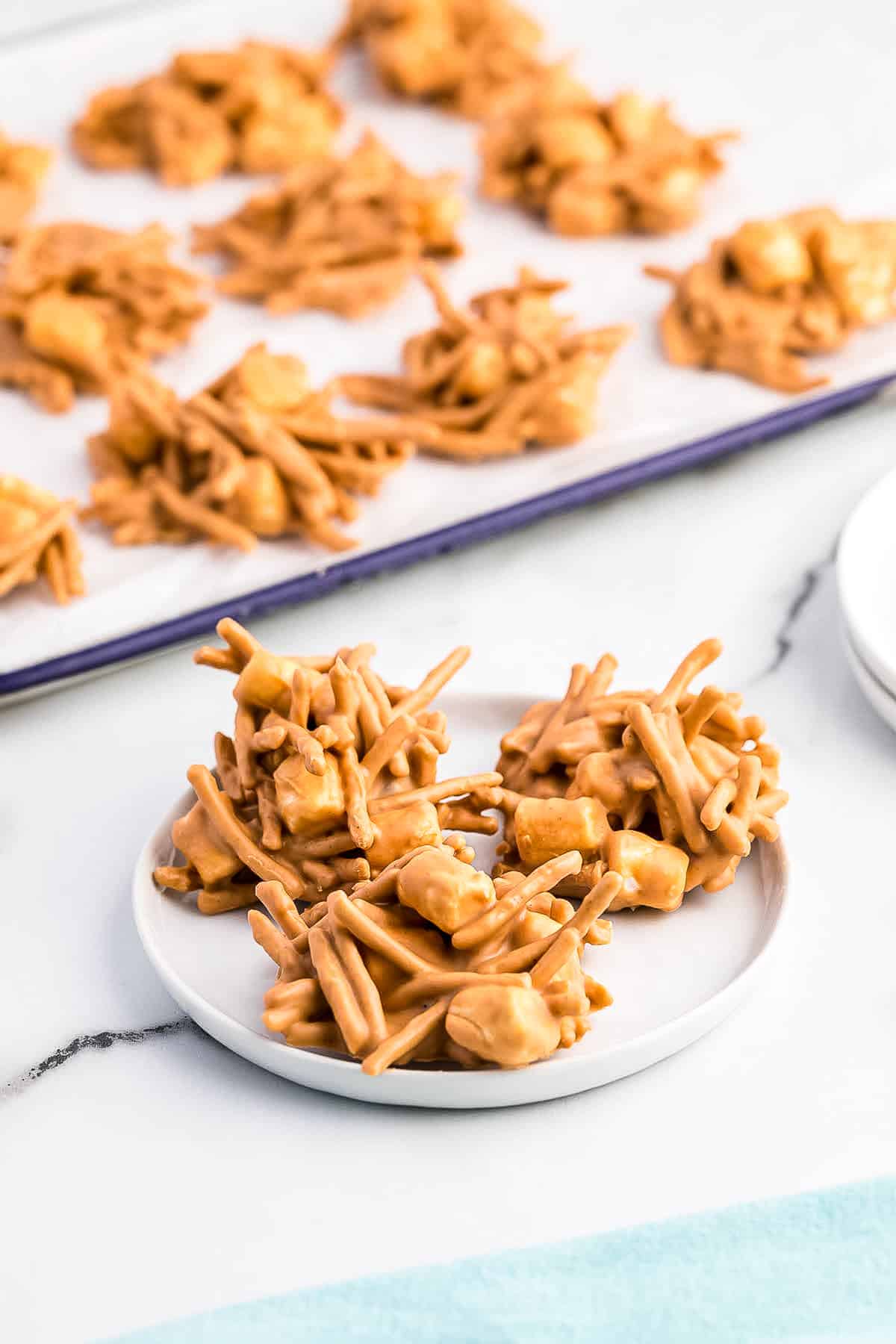 three haystacks displayed on a white plate.