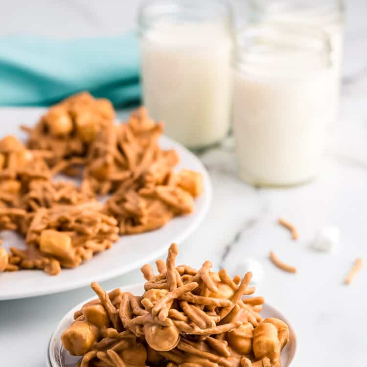 A large haystack on a plate with milk in the background.