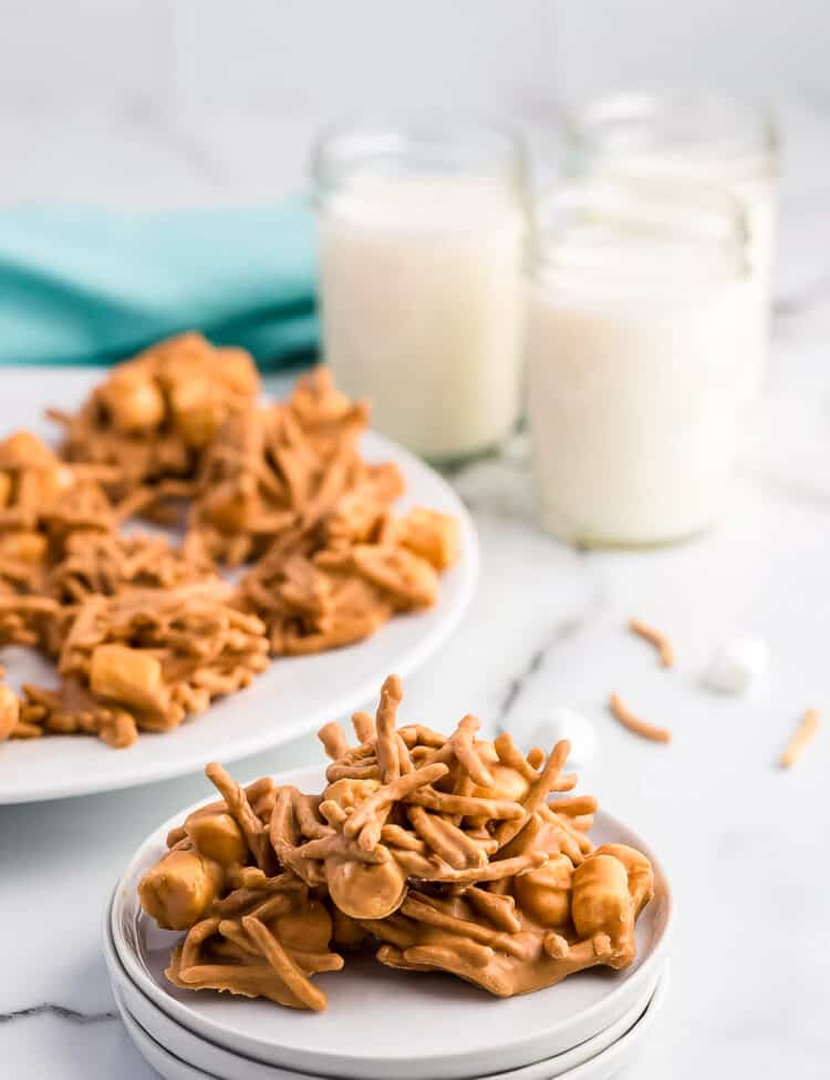 A large haystack on a plate with milk in the background.