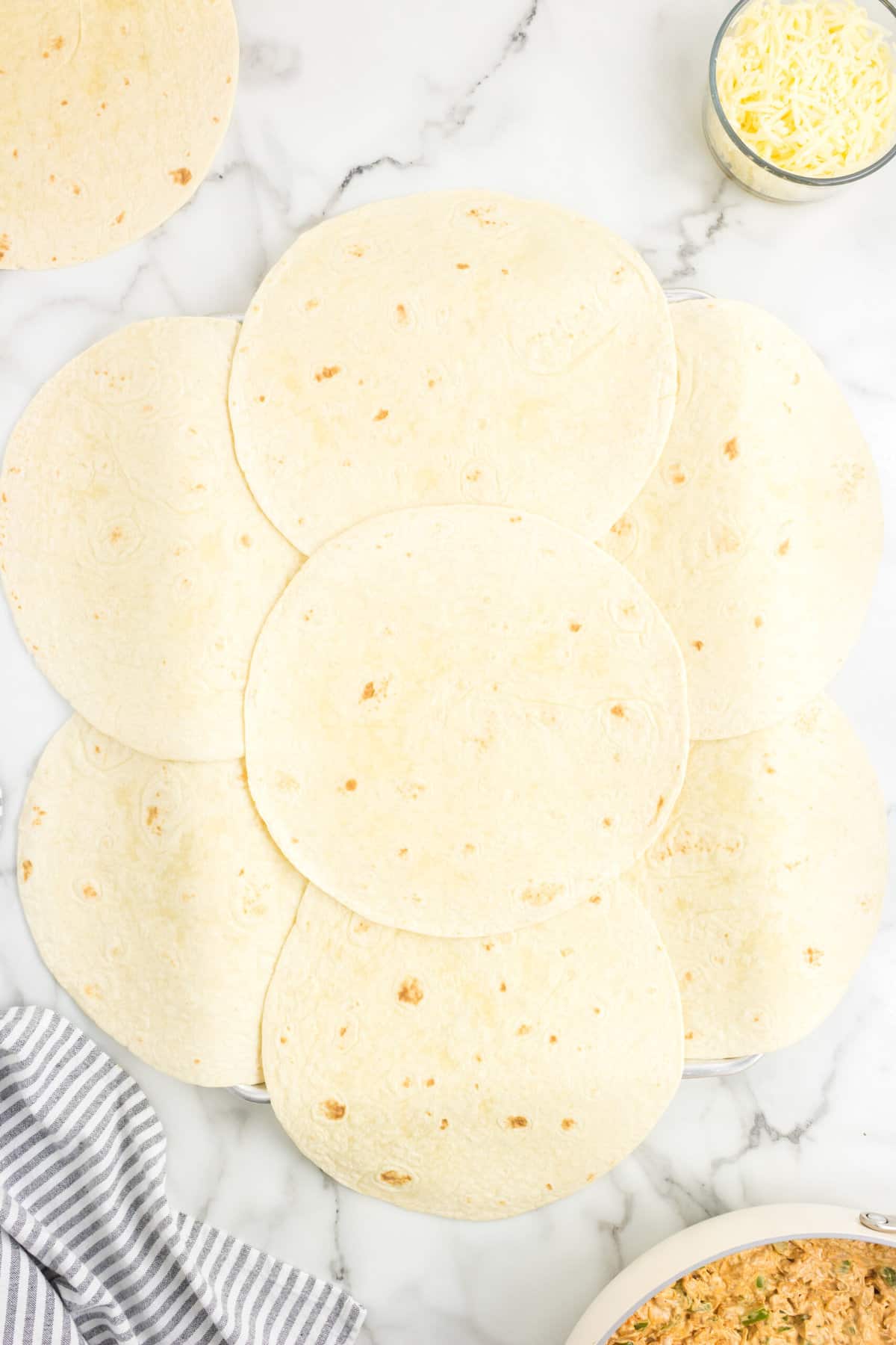 Adding Center Tortilla to Layer for Sheet Pan Quesadillas Recipe