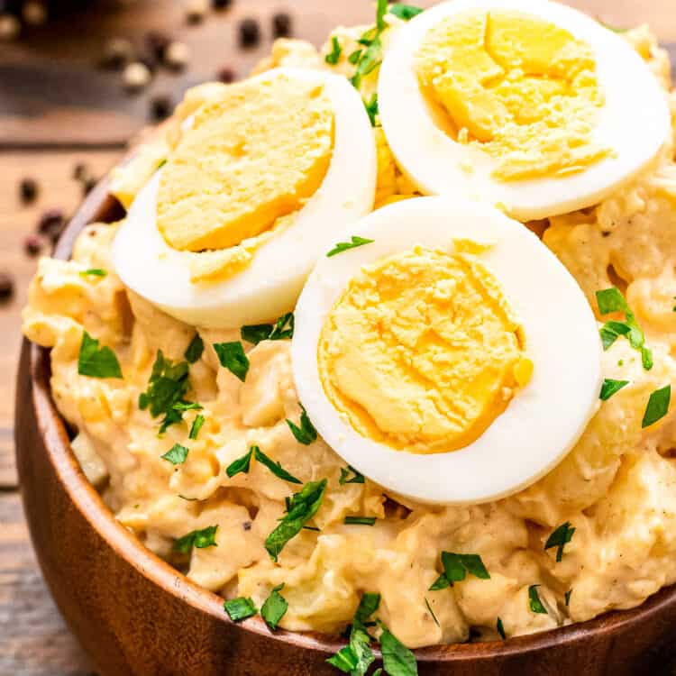 Brown wooden bowl with potato salad