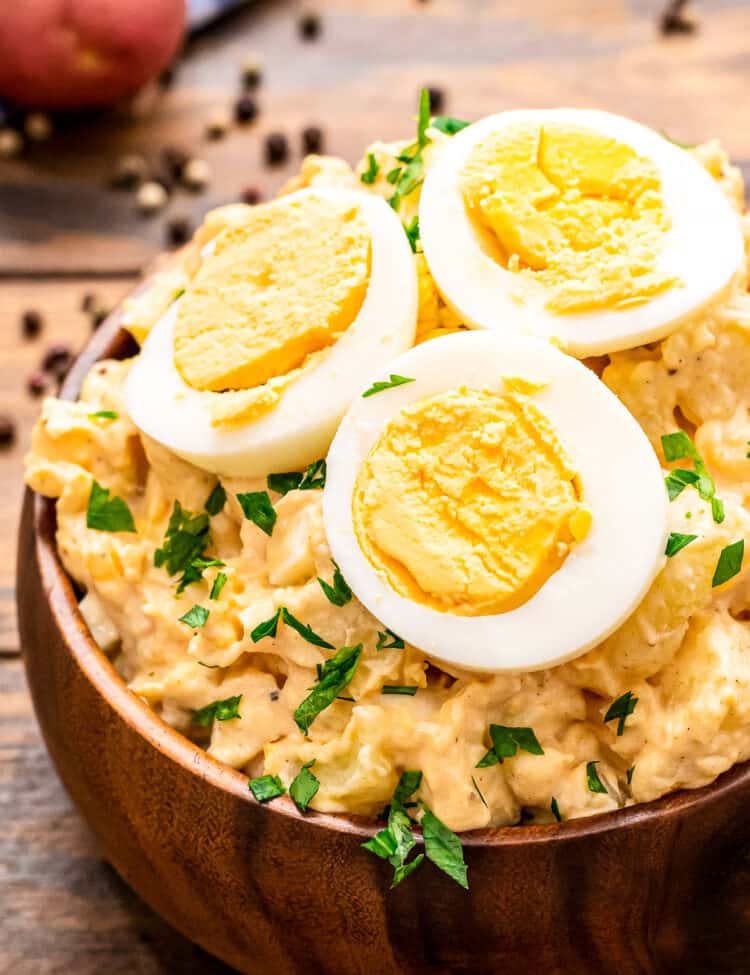 Brown wooden bowl with potato salad