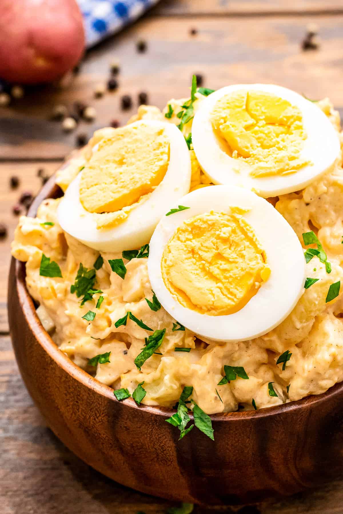 Brown wooden bowl with potato salad