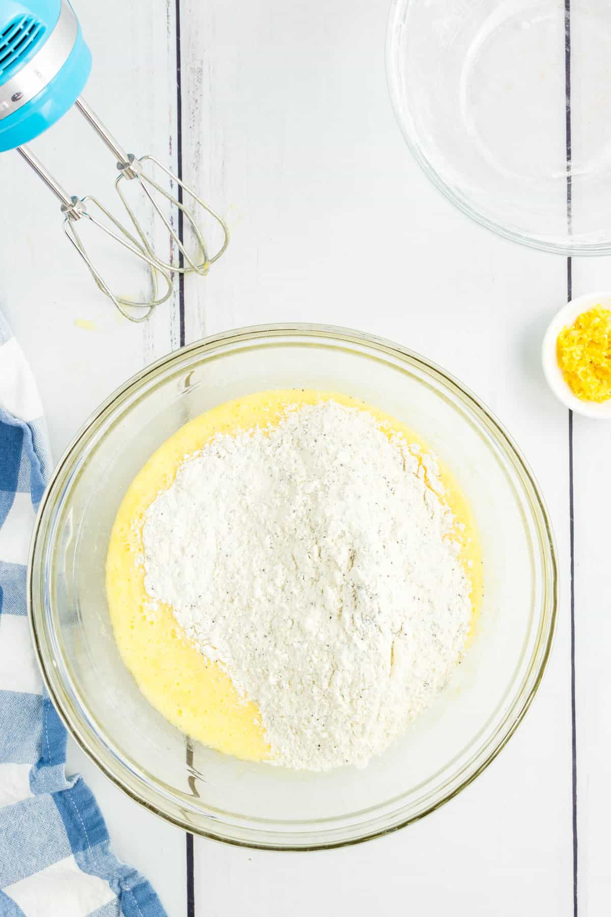 Folding Dry Ingredients into Wet Mixture for Lemon Poppy Seed Muffins Recipe