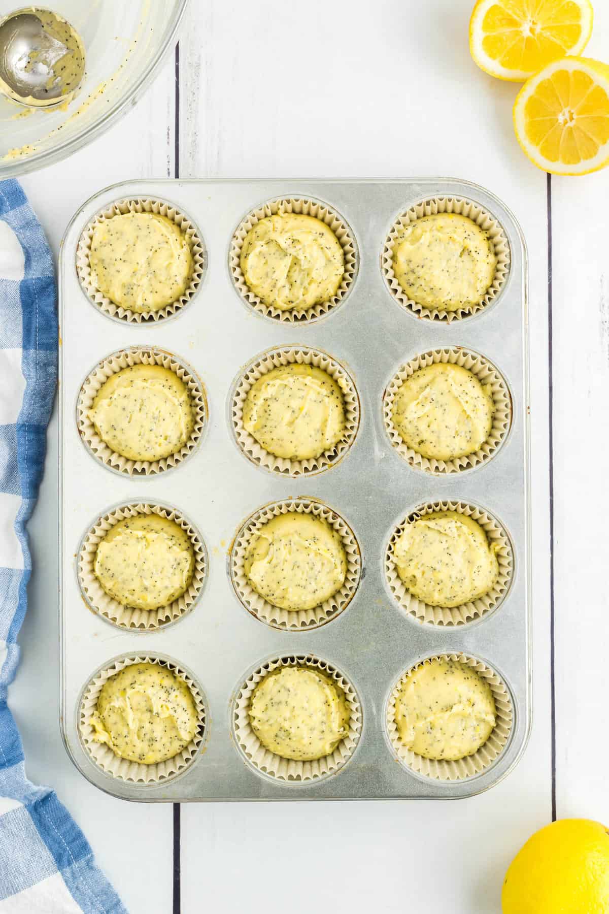 Lemon Poppy Seed Muffins in Liners in Muffin Tin Ready for the Oven