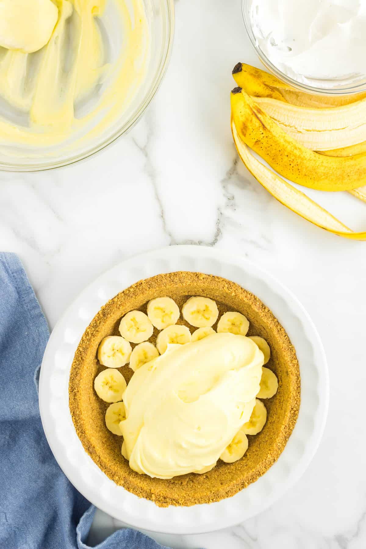 Adding Pie Filling to Banana-Lined Crust for No Bake Banana Cream PIe Recipe