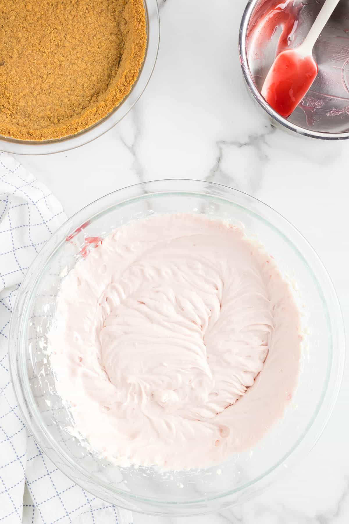 Blending Strawberries and Cream Cheese Mixture in Bowl for No Bake Strawberry Cheesecake 