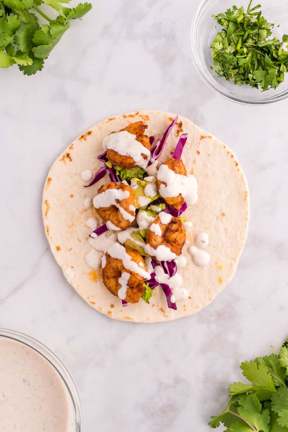 Drizzling Cilantro Lime Dressing on Shrimp Taco