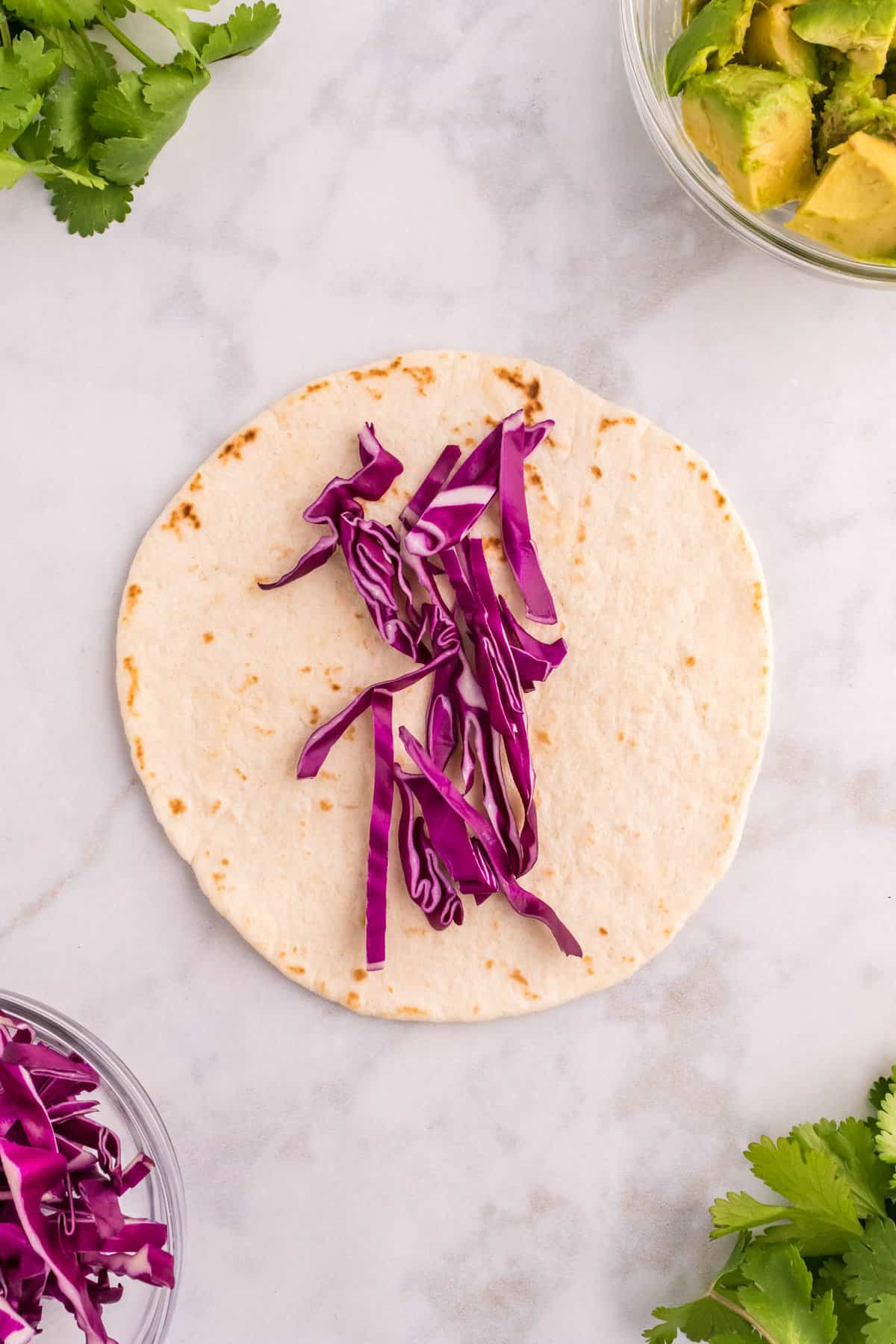 Adding Shredded Red Cabbage for Shrimp Tacos