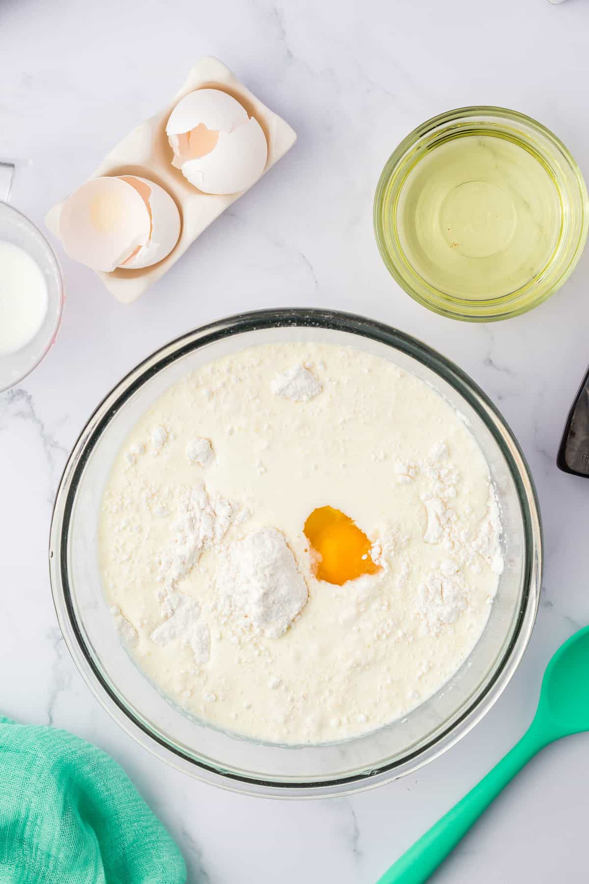 Adding in Wet Ingredients to Mixing Bowl for Strawberry Muffins Recipe