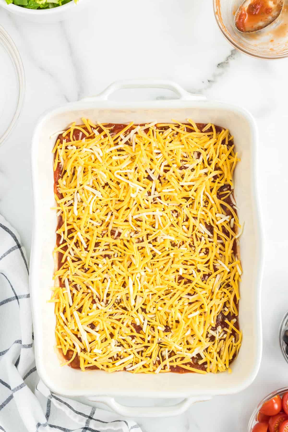 Easy Taco Dip in Pan Topped with Salsa and Cheese