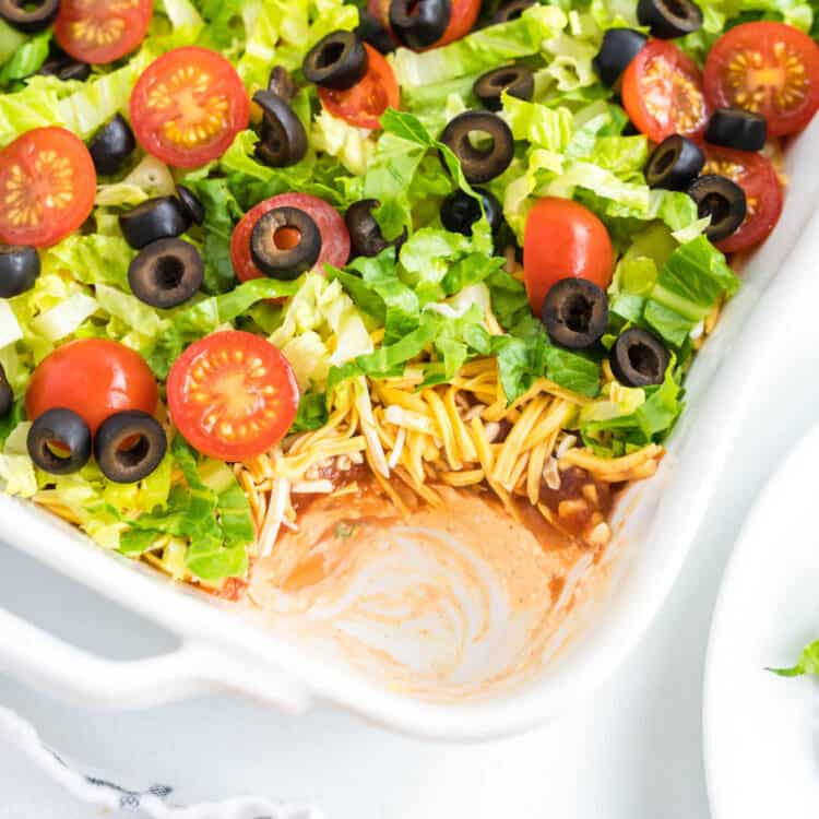 Square cropped image of taco dip in white dish