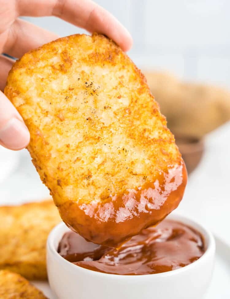 Frozen Hash browns in air fryer dipped in ketchup