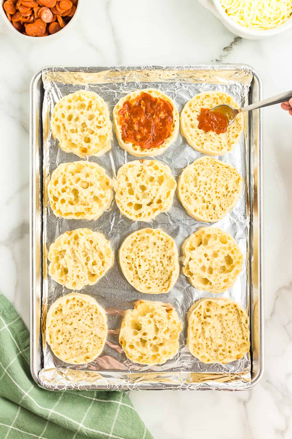 Add Pizza Sauce to the English Muffins