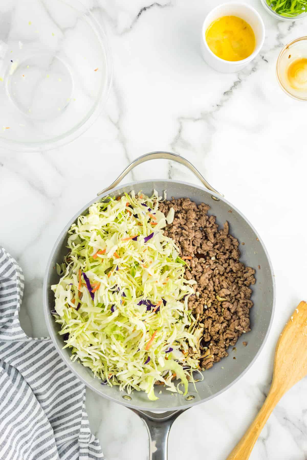 Adding coleslaw mix to ground meat for Egg Roll in a Bowl Recipe