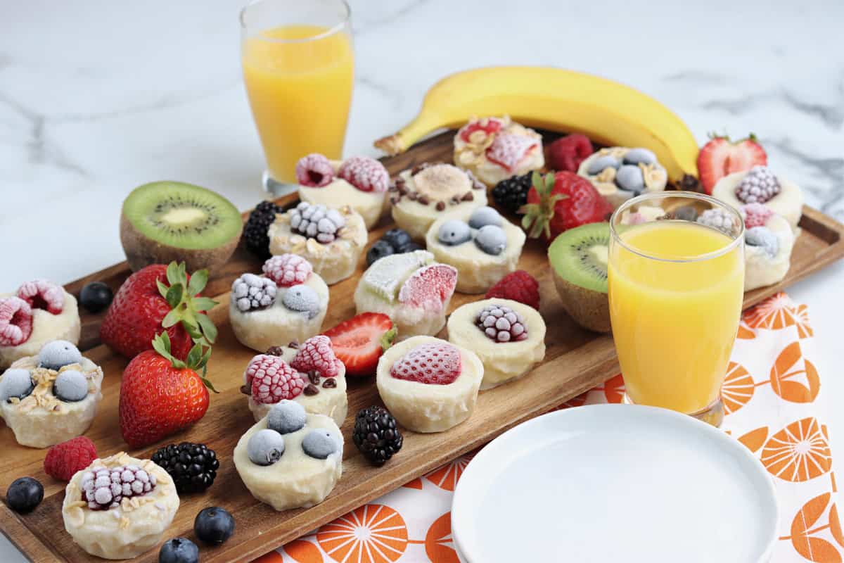 a Tray full of yogurt bites with orange juice on the side