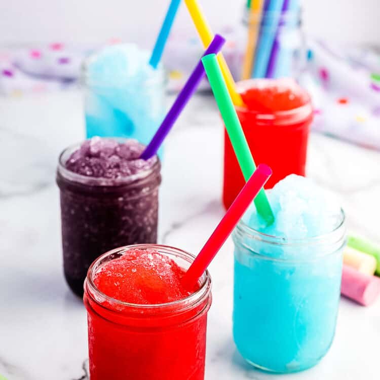 Different flavors of slushies displayed in mason jars.