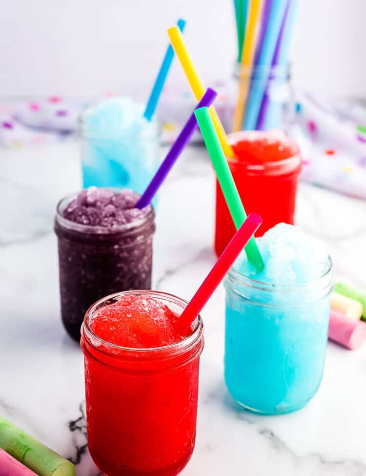 Different flavors of slushies displayed in mason jars.