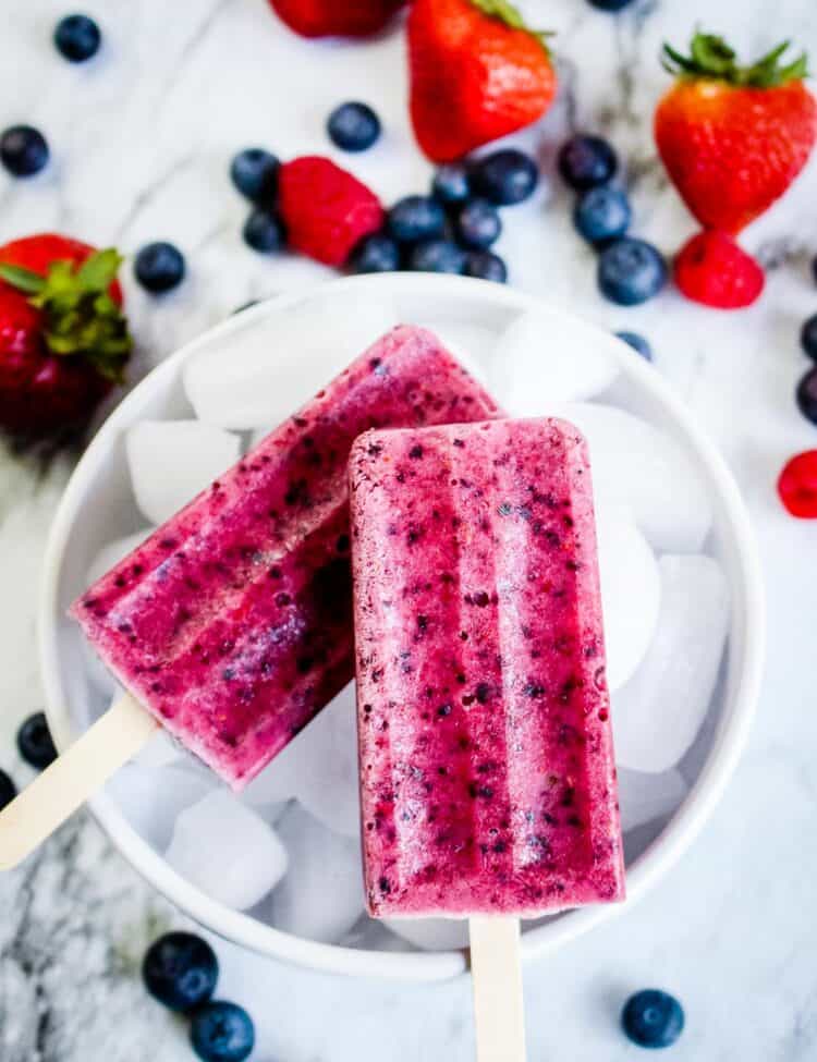 Photo of two Completed Berry Popsicles on a Bowl of Ice