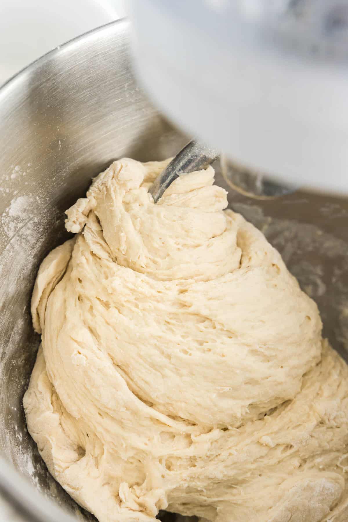 Mixing Easy Homemade Pizza Dough with a stand mixer using a dough hook leaving time for the dough to proof