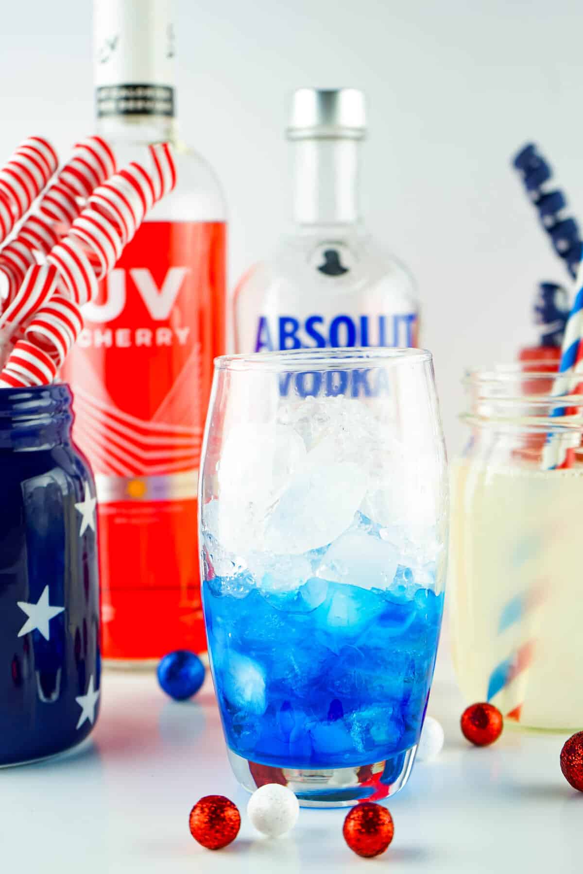 Blue Curacao and ice in glass for Red White and Blue Layered Cocktail 